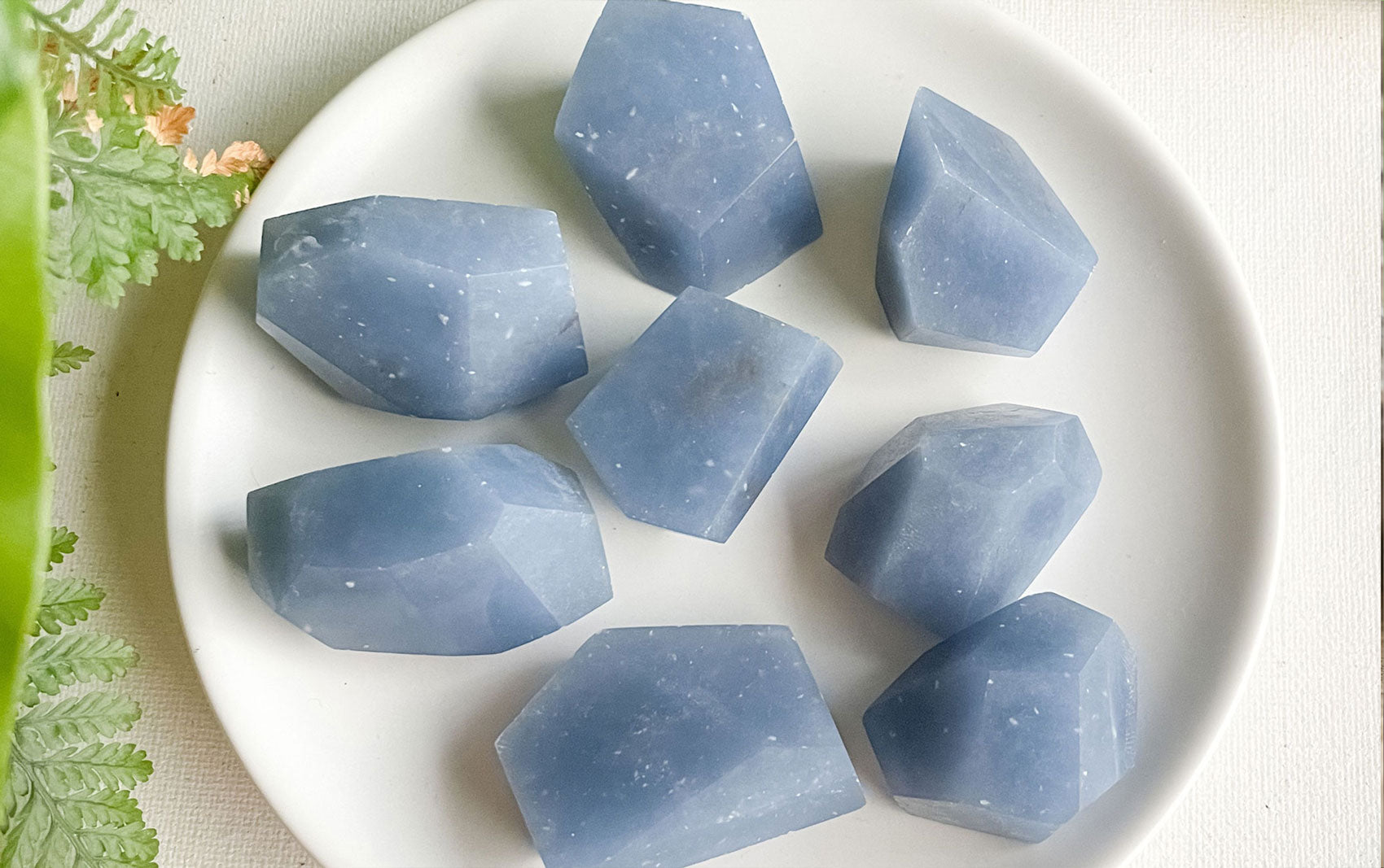 light blue Angelite gemstone with a matte finish and rounded shape