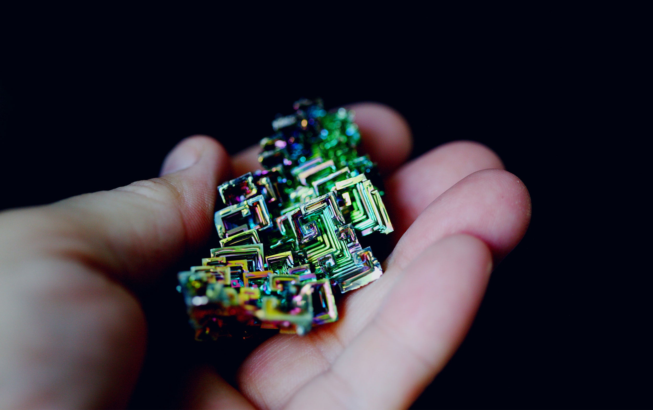 Vibrant geometric patterns on a Bismuth crystal with iridescent colors