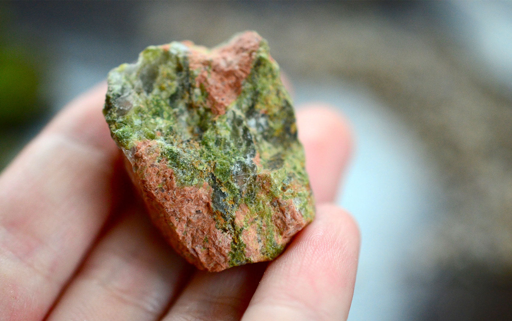 A polished Unakite gemstone with pink color