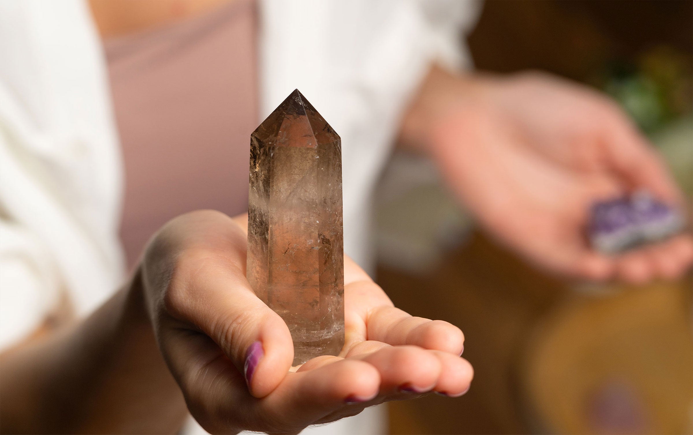 A transparent brown Smoky Quartz gemstone with a smooth, polished surface and natural earthy tones