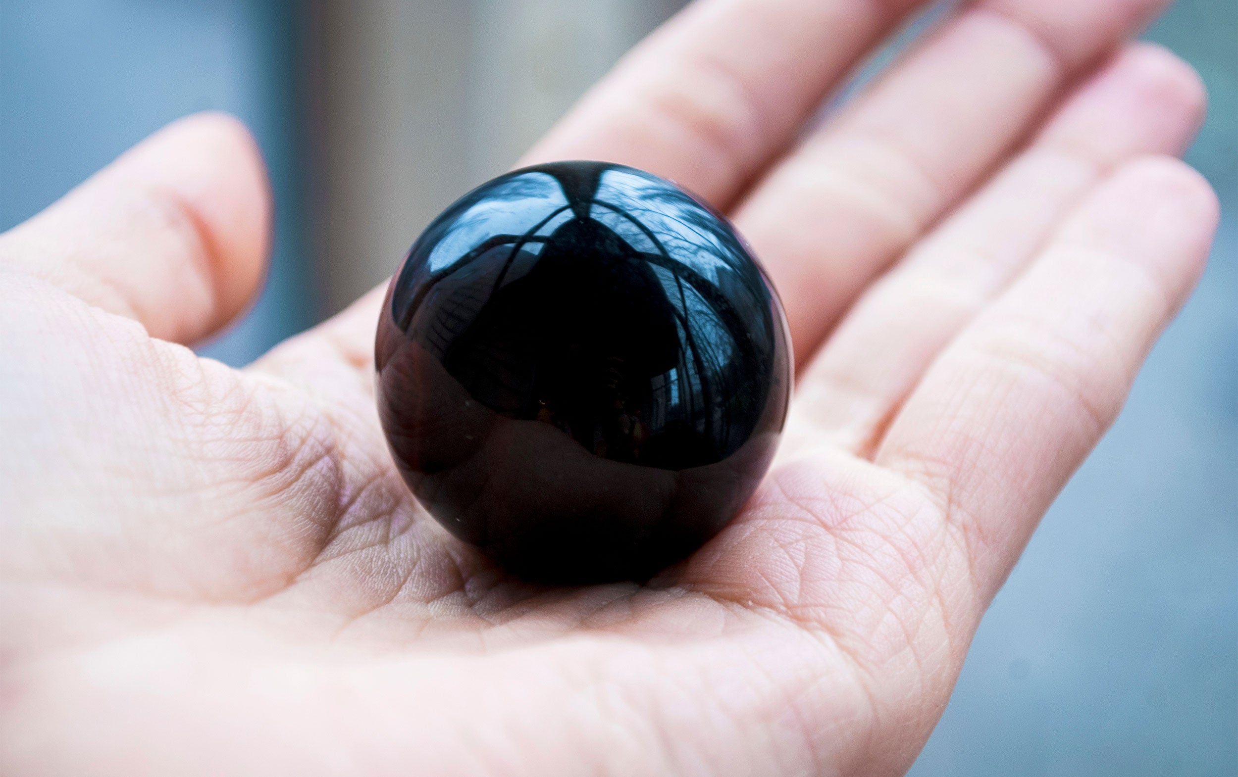 Obsidian stone showcasing its glossy and black surface with natural sheen