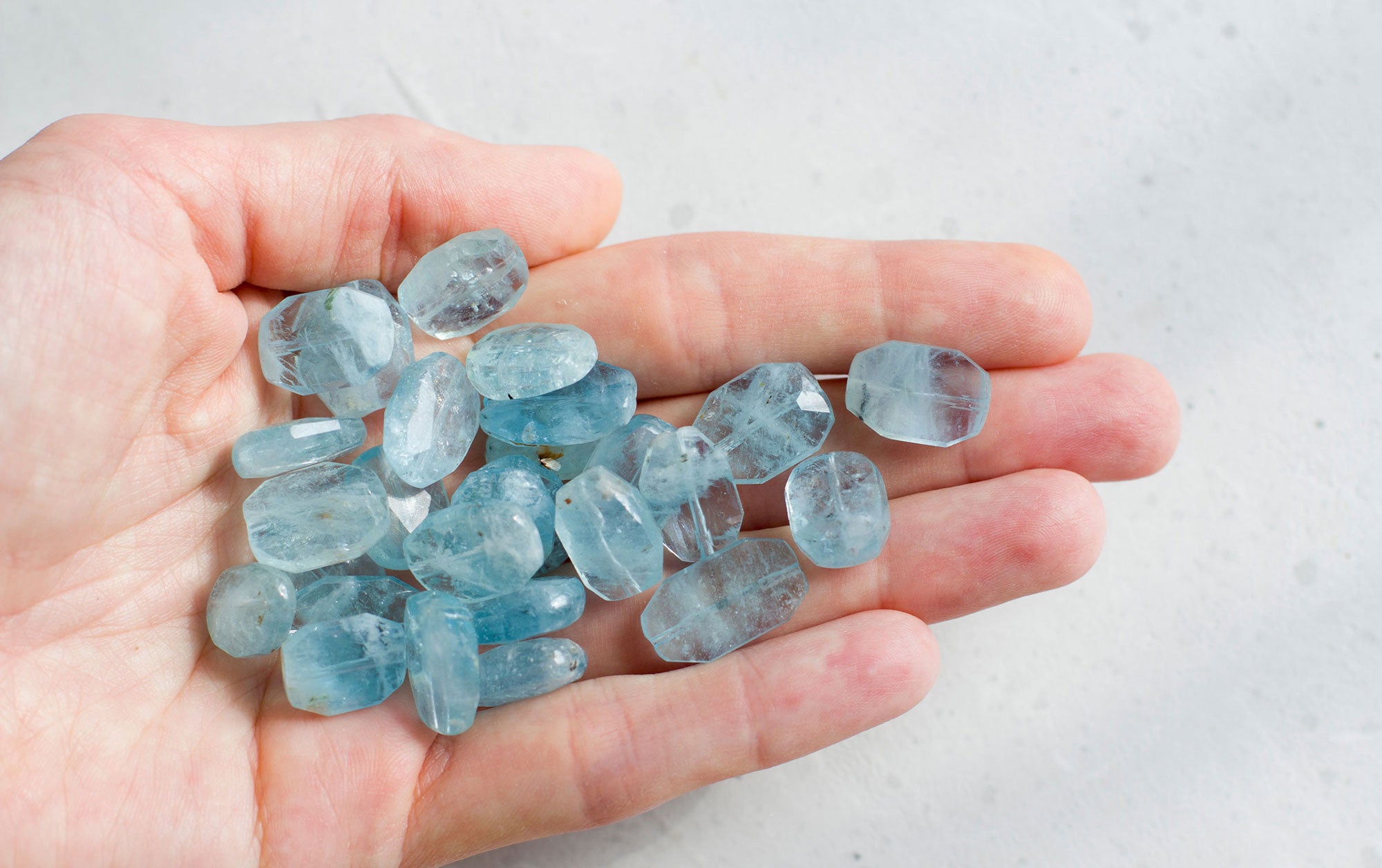 Aquamarine raw stones in the hand