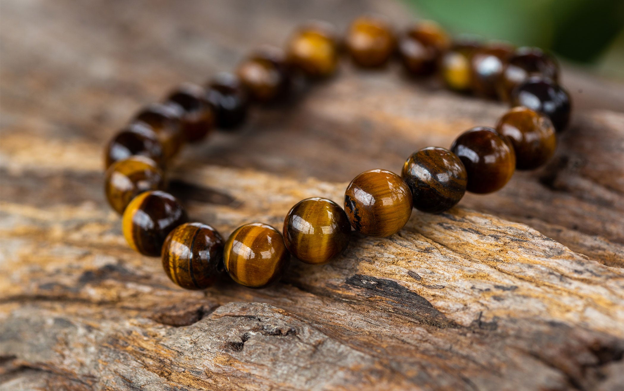 Tiger eye stone with golden brown bands and a smooth polished surface