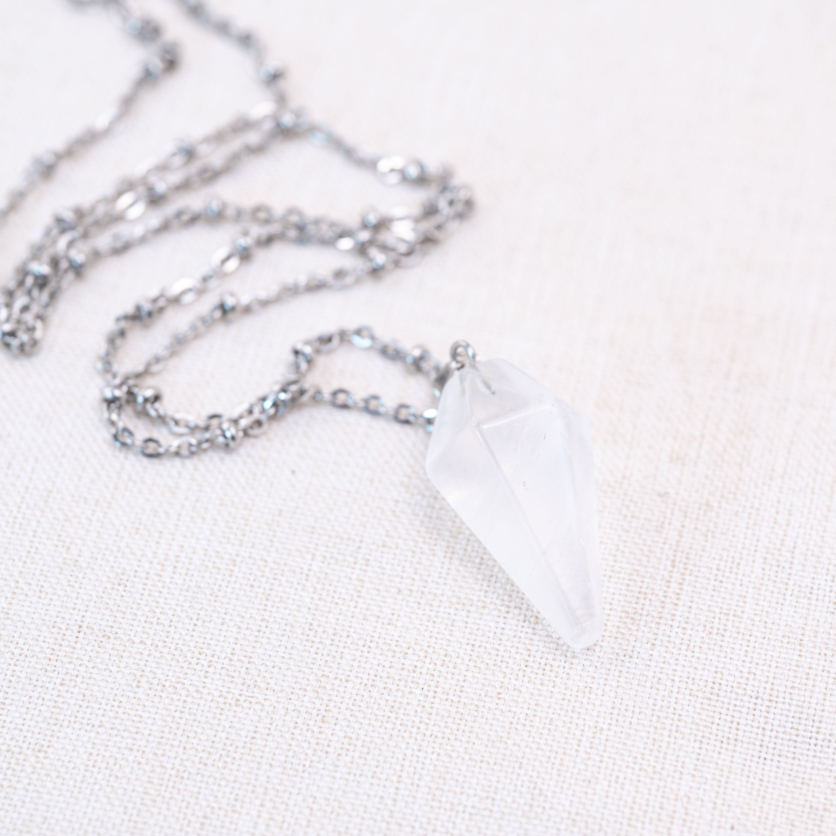 The Clear Quartz Conical Pendant emits a subtle brilliance, making it a versatile accessory for various occasions.