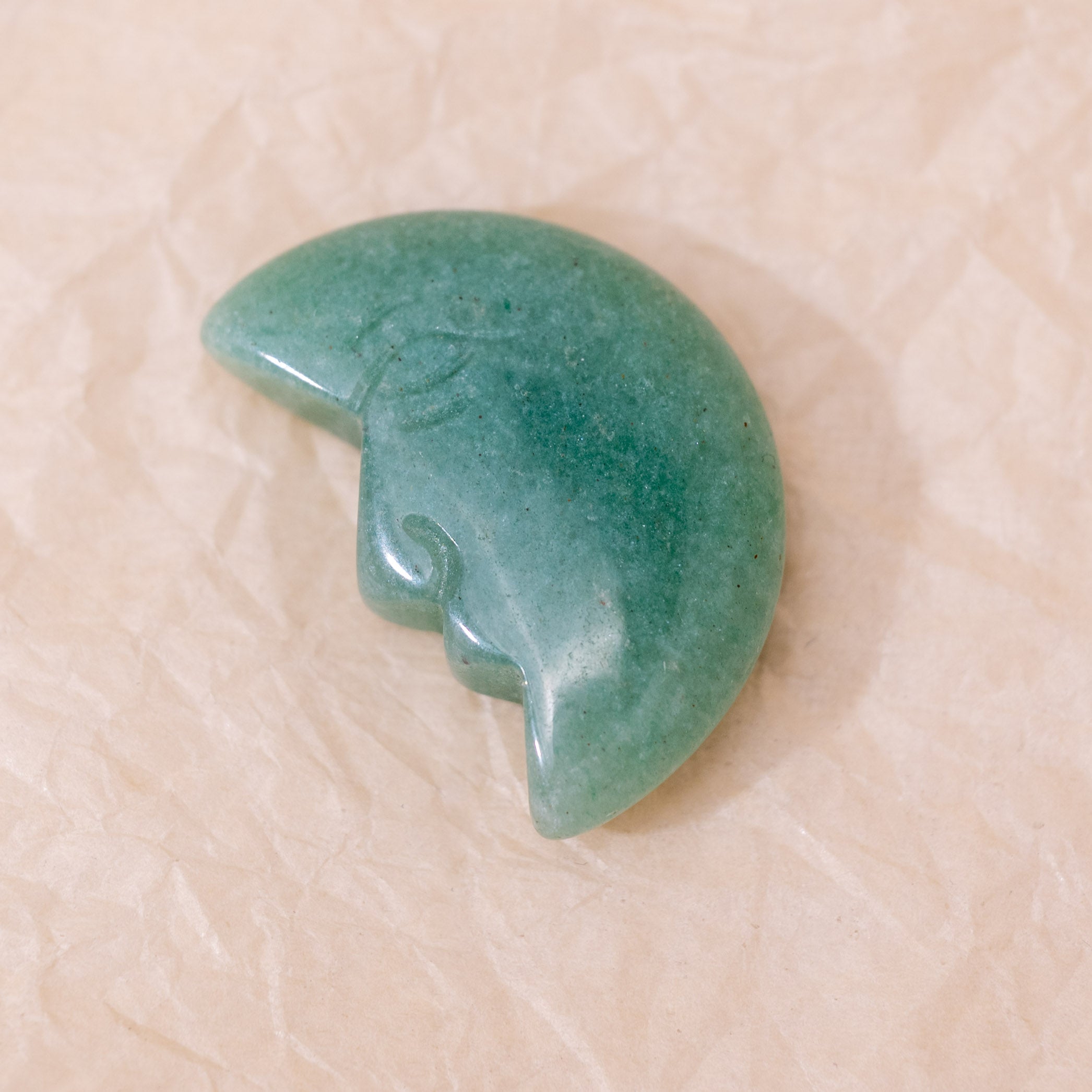 The Green Aventurine Mini Moonface brings positivity to your workspace.
