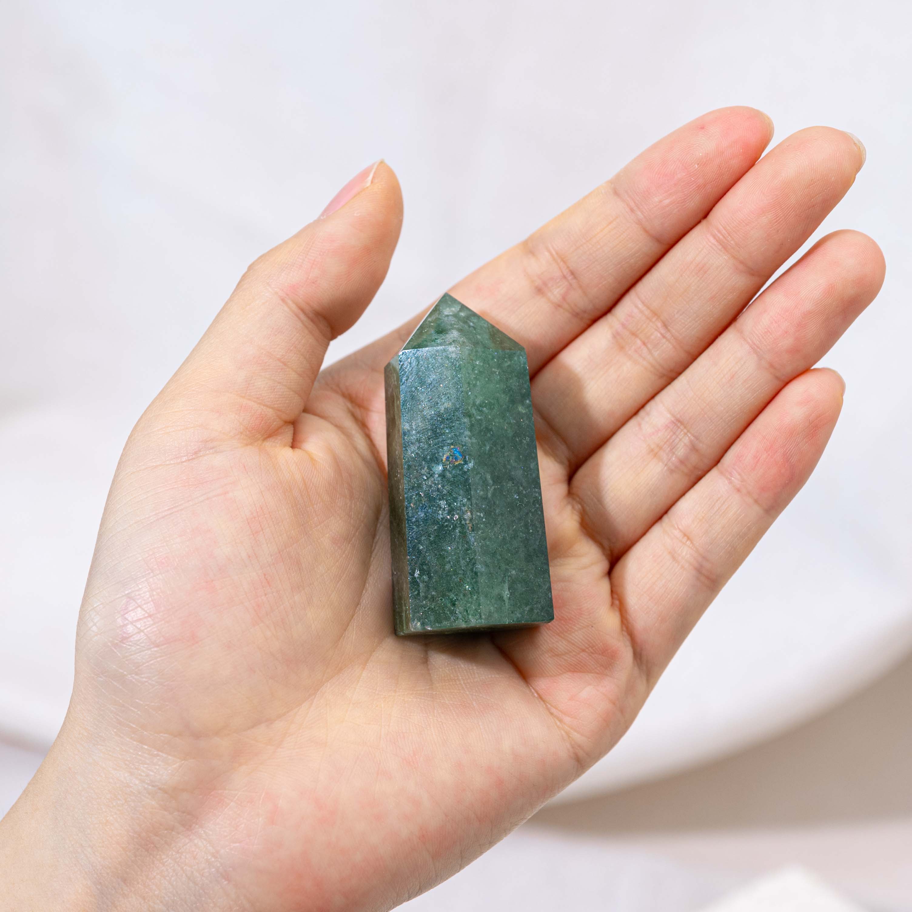 Green Strawberry Quartz Point with vibrant green hues and unique inclusions.