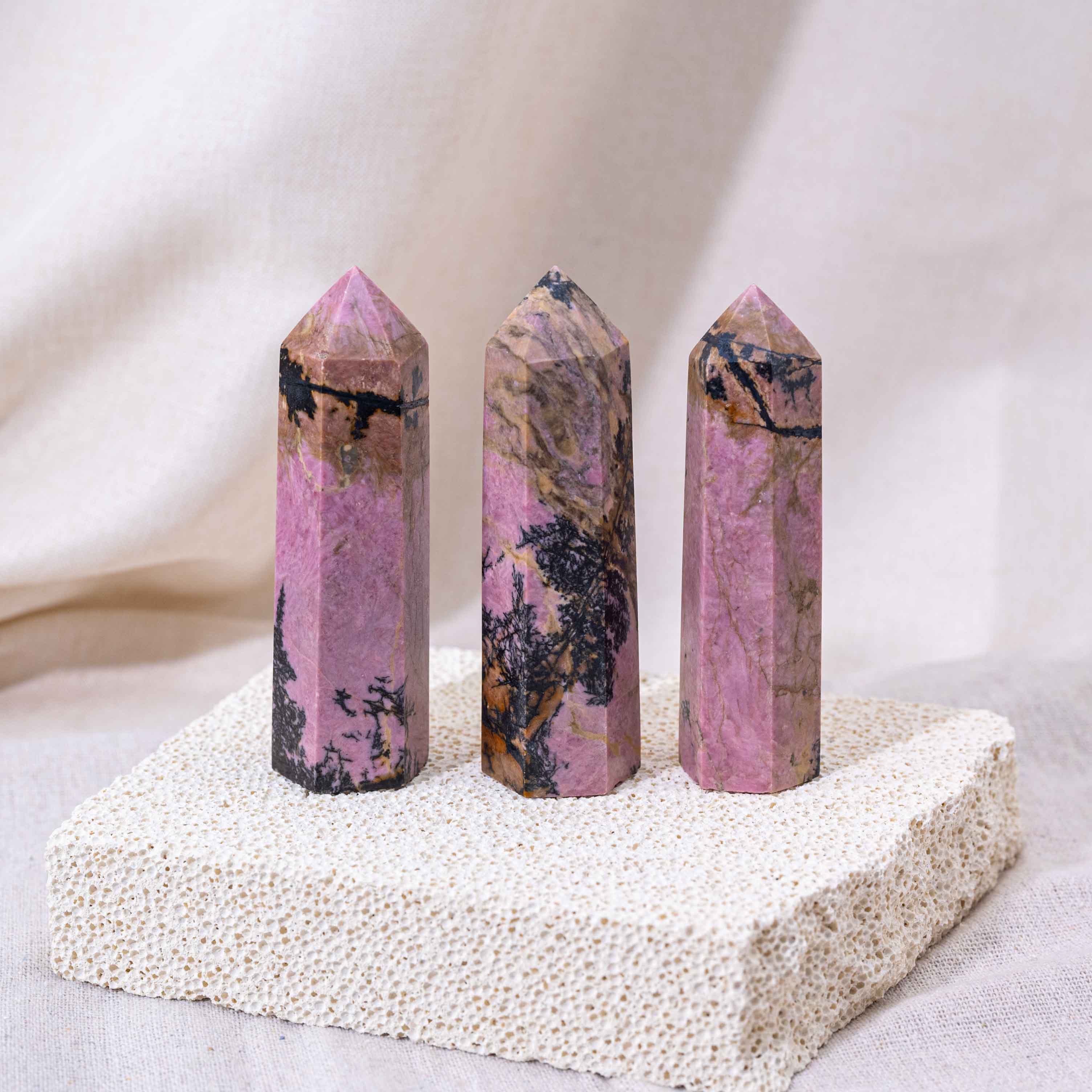 Unique Pink Rhodonite Point with intricate patterns.