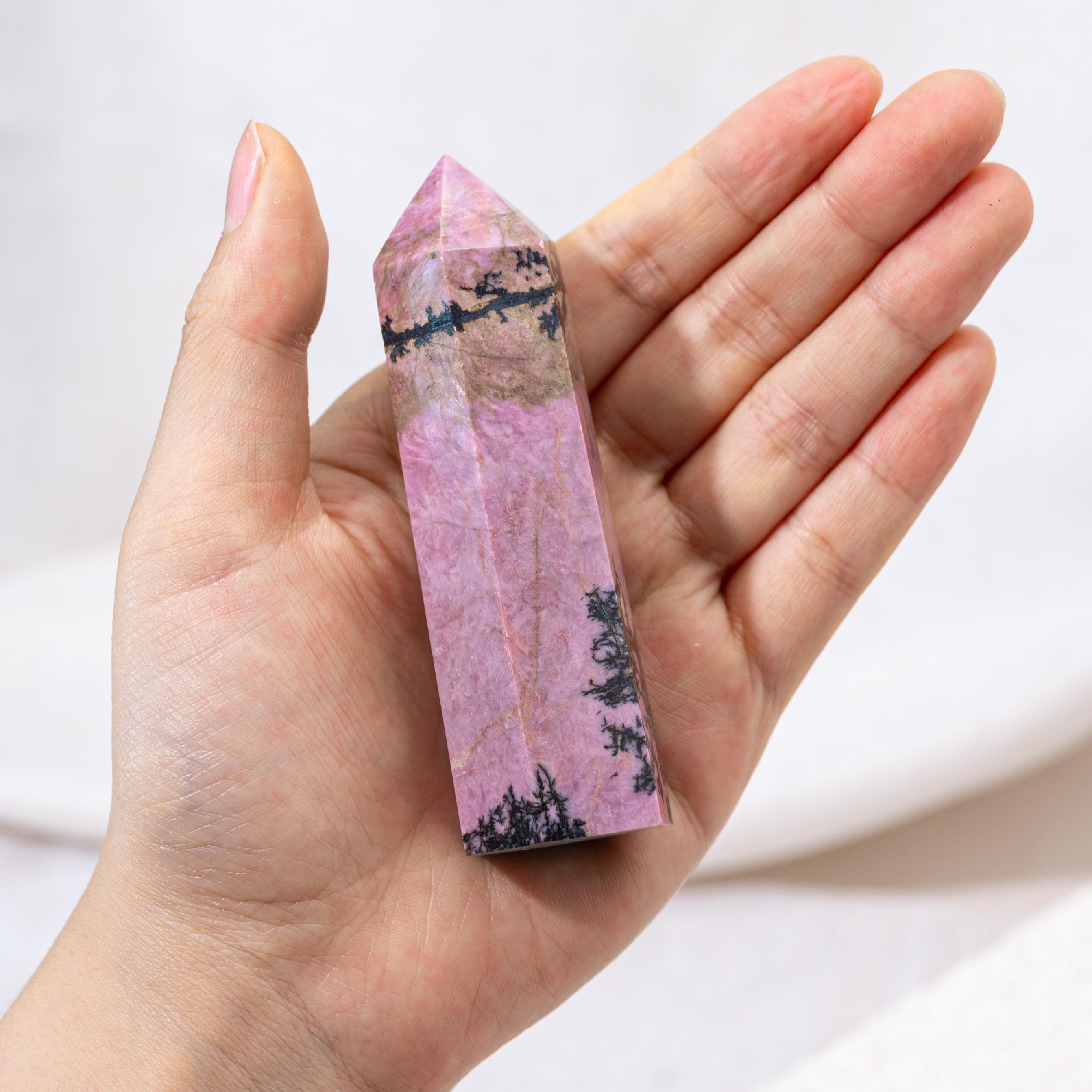 Polished Pink Rhodonite Point, perfect for display.