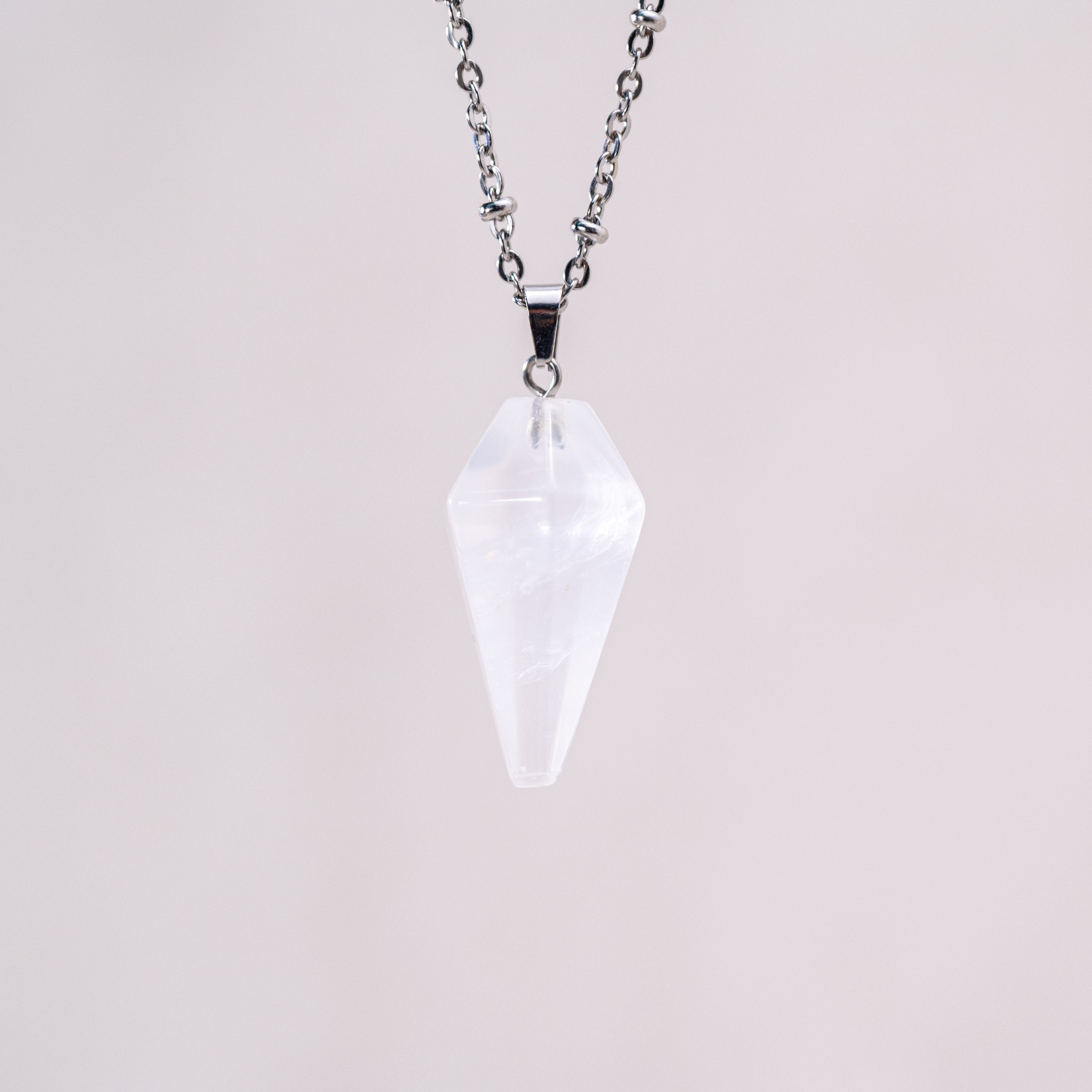 This pendant is handcrafted to highlight the pure, transparent qualities of clear quartz, making it a standout piece.