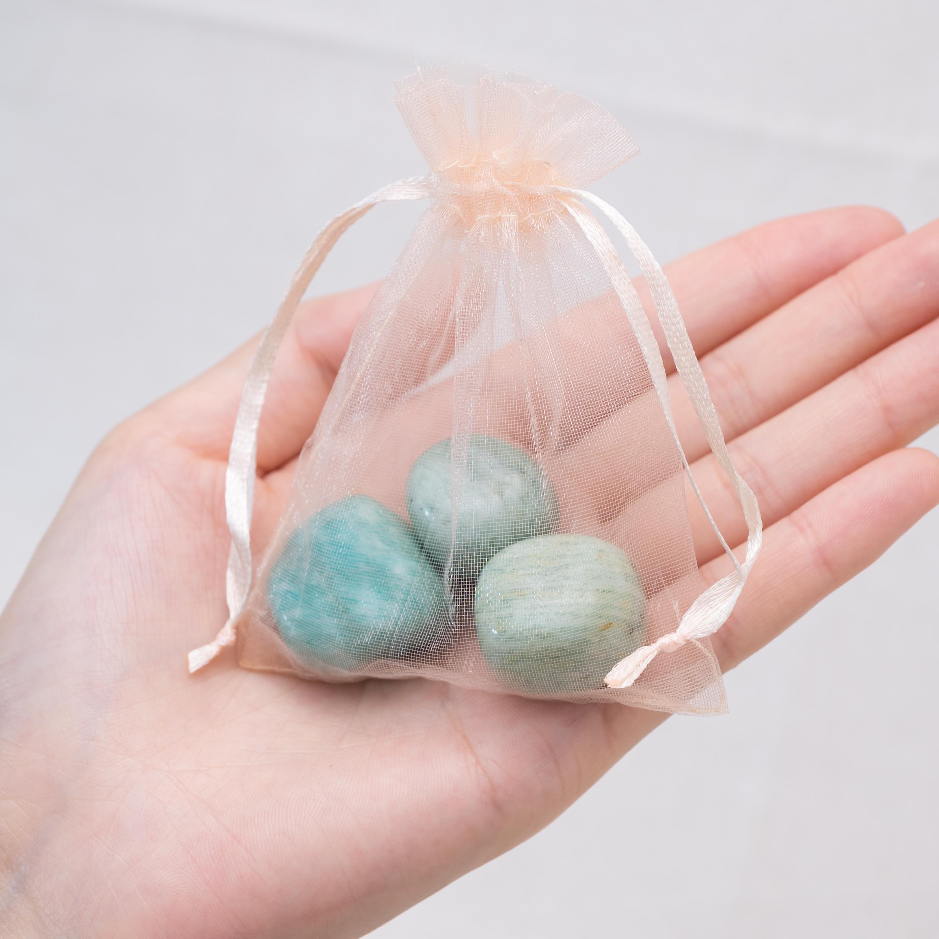 Laid-out Amazonite tumbled stones for tranquility and balance