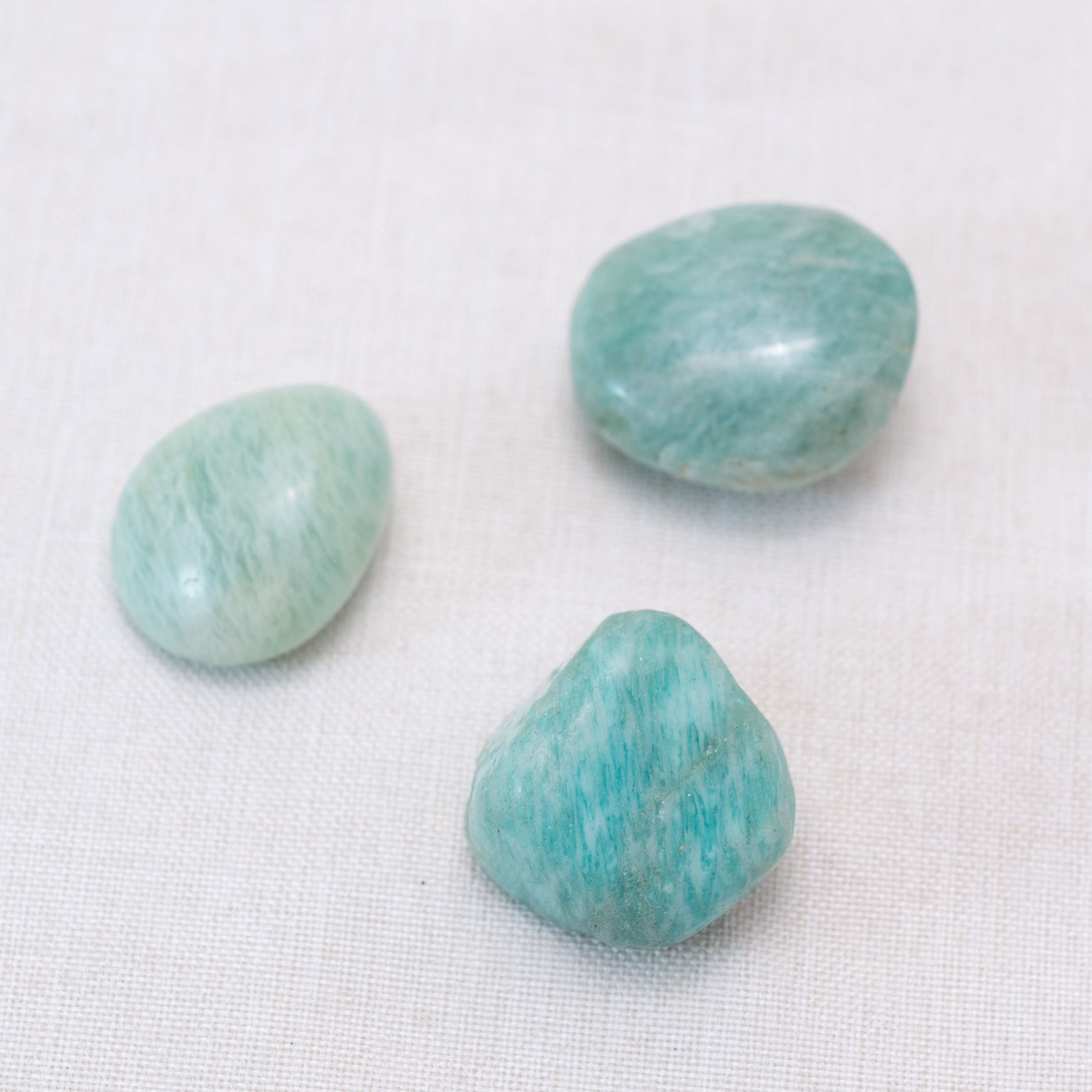 Hand cupping Amazonite tumbled stone for soothing stress