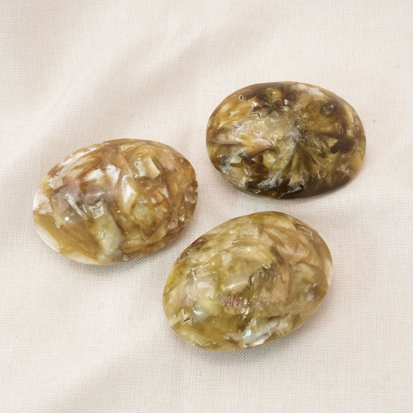 The Golden Lepidolite Palm Stone enhances spiritual growth and supports meditation practices