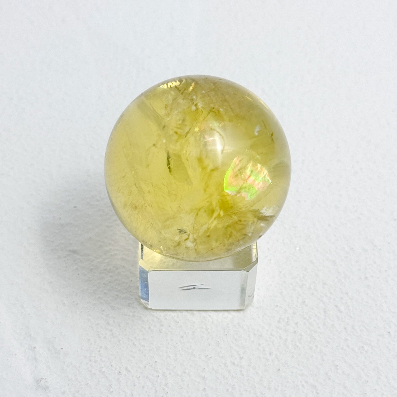 Golden yellow citrine sphere reflecting soft light in serene setting