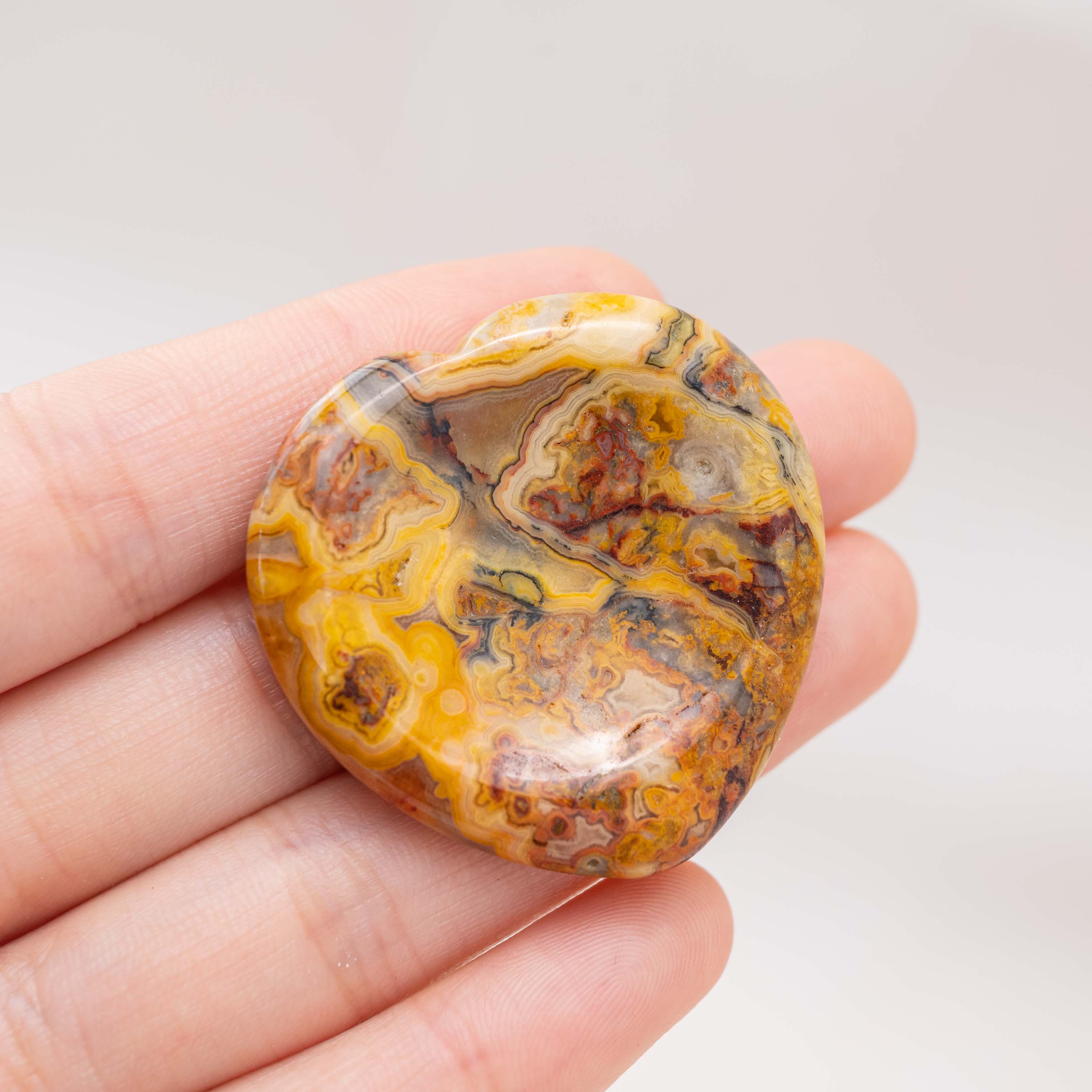 The Crazy Agate Heart Worry Stone is vibrant and dynamic, perfect for emotional healing