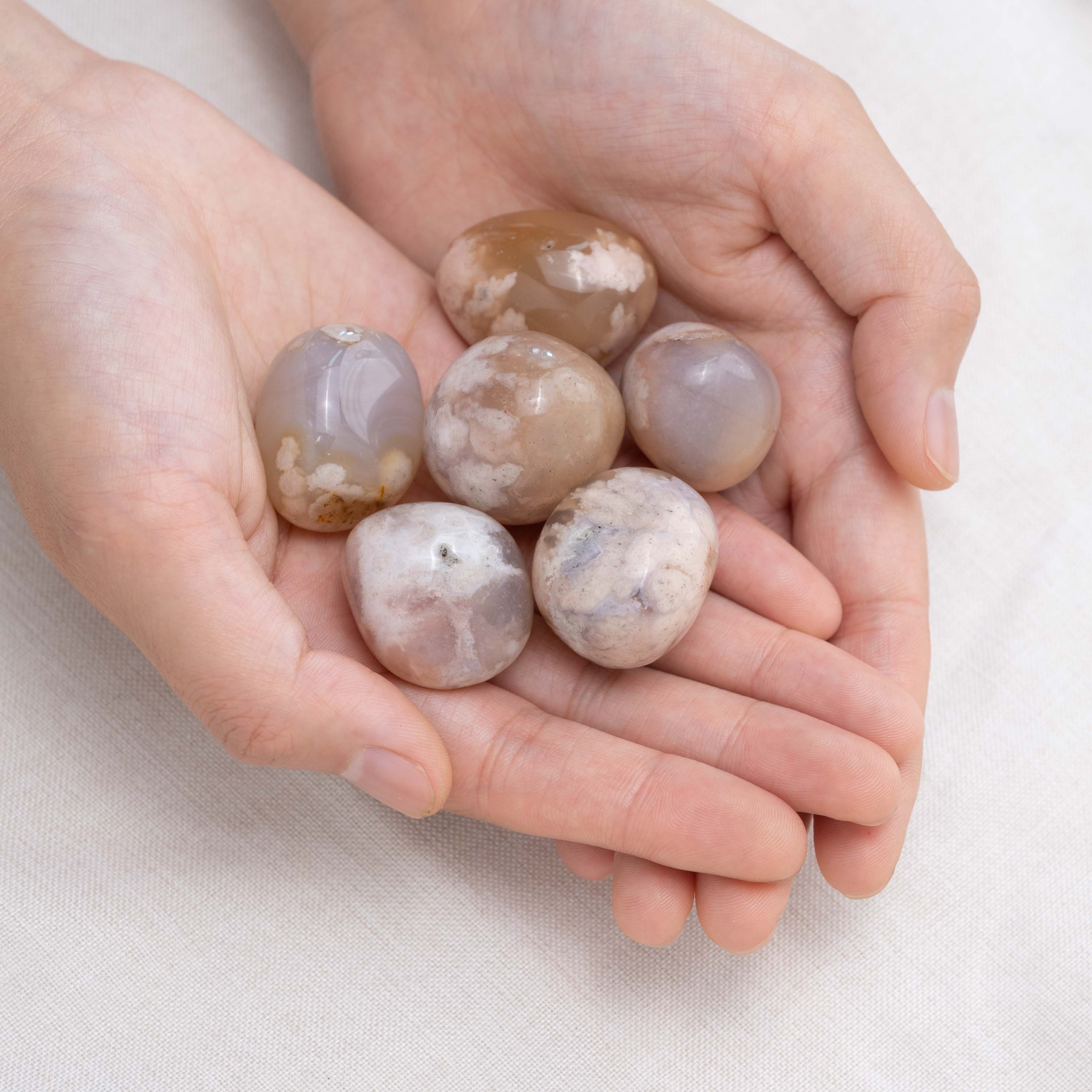 Hand cupping Flower Agate tumbled stone for emotional healing