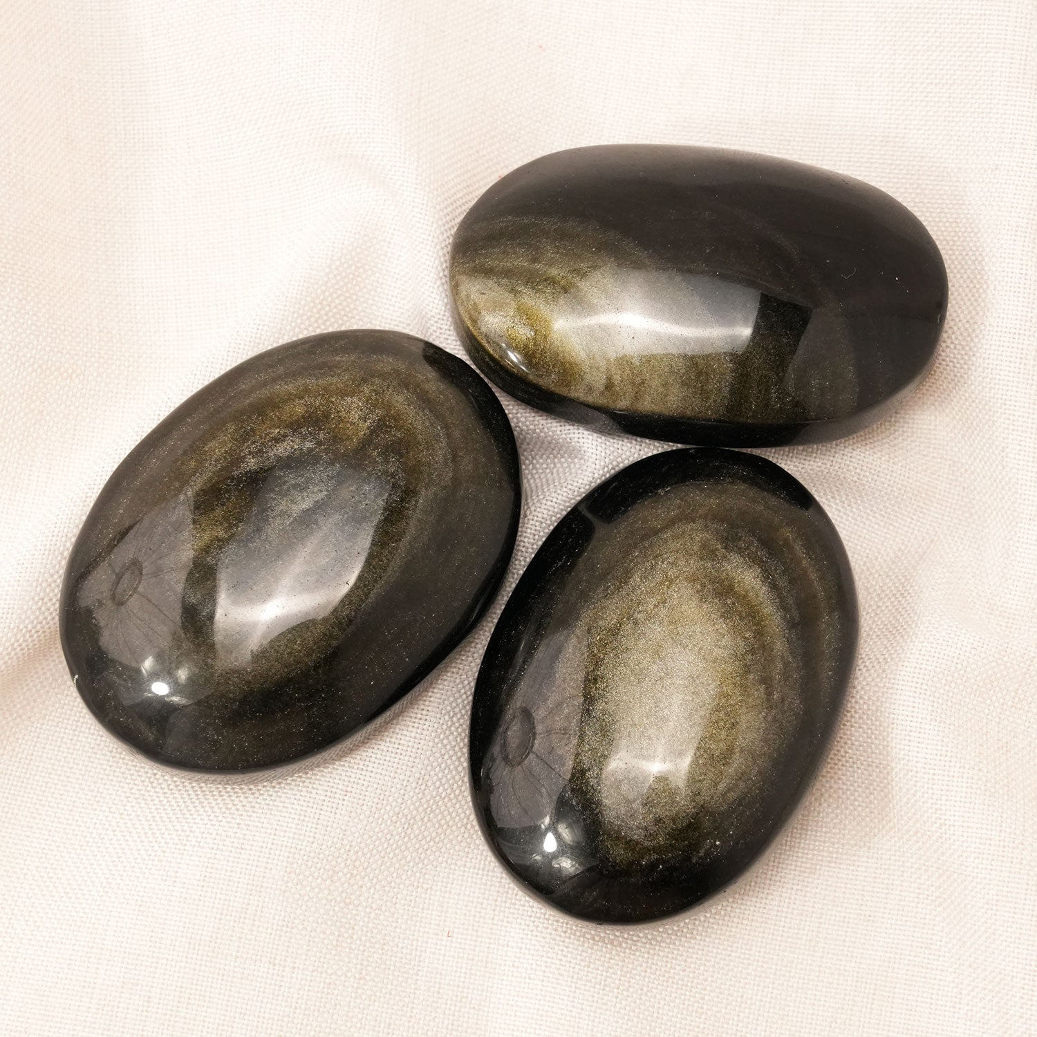 Golden Obsidian Palm Stone enhancing intuition and psychic protection
