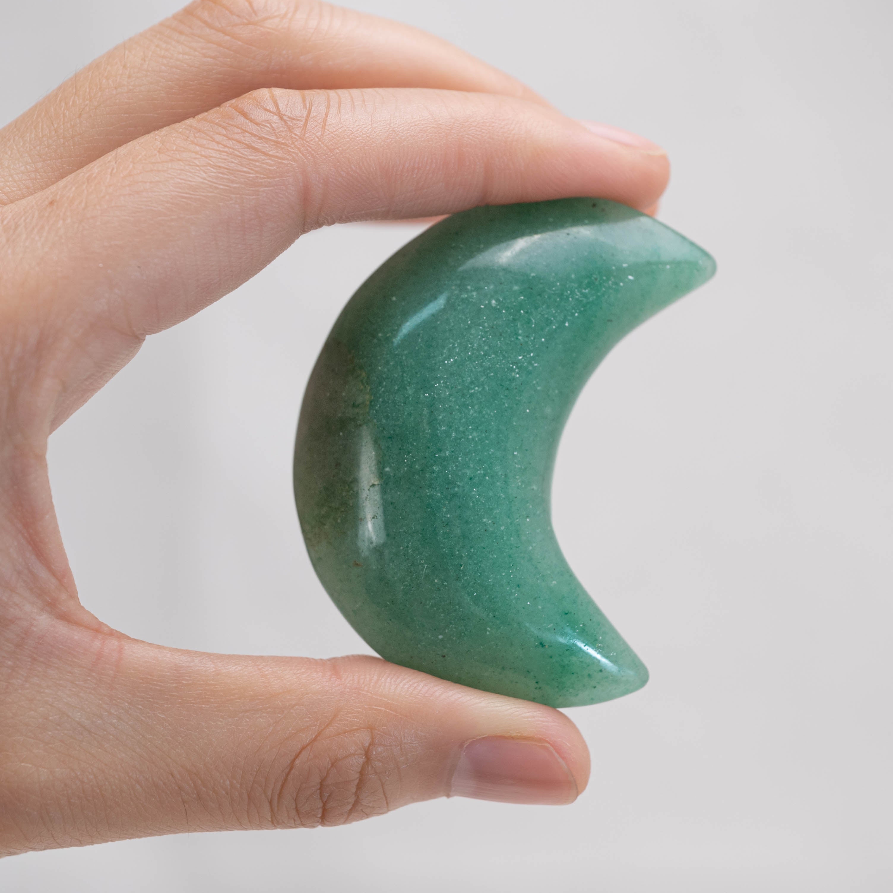Hand holding Green Aventurine Star/Moon Palm Stone