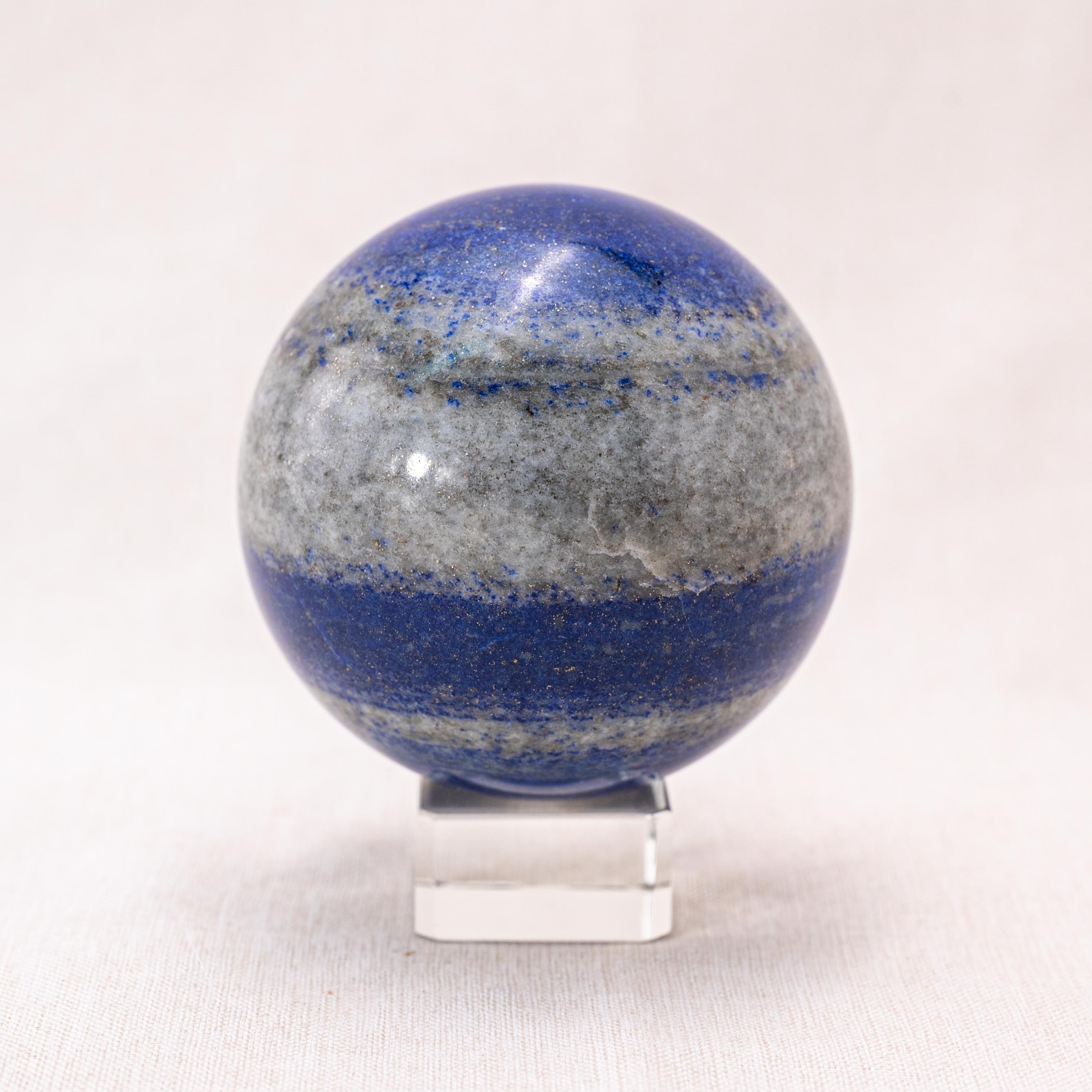 Deep blue lapis lazuli sphere with gold flecks, perfect for enhancing your home decor and promoting tranquility.