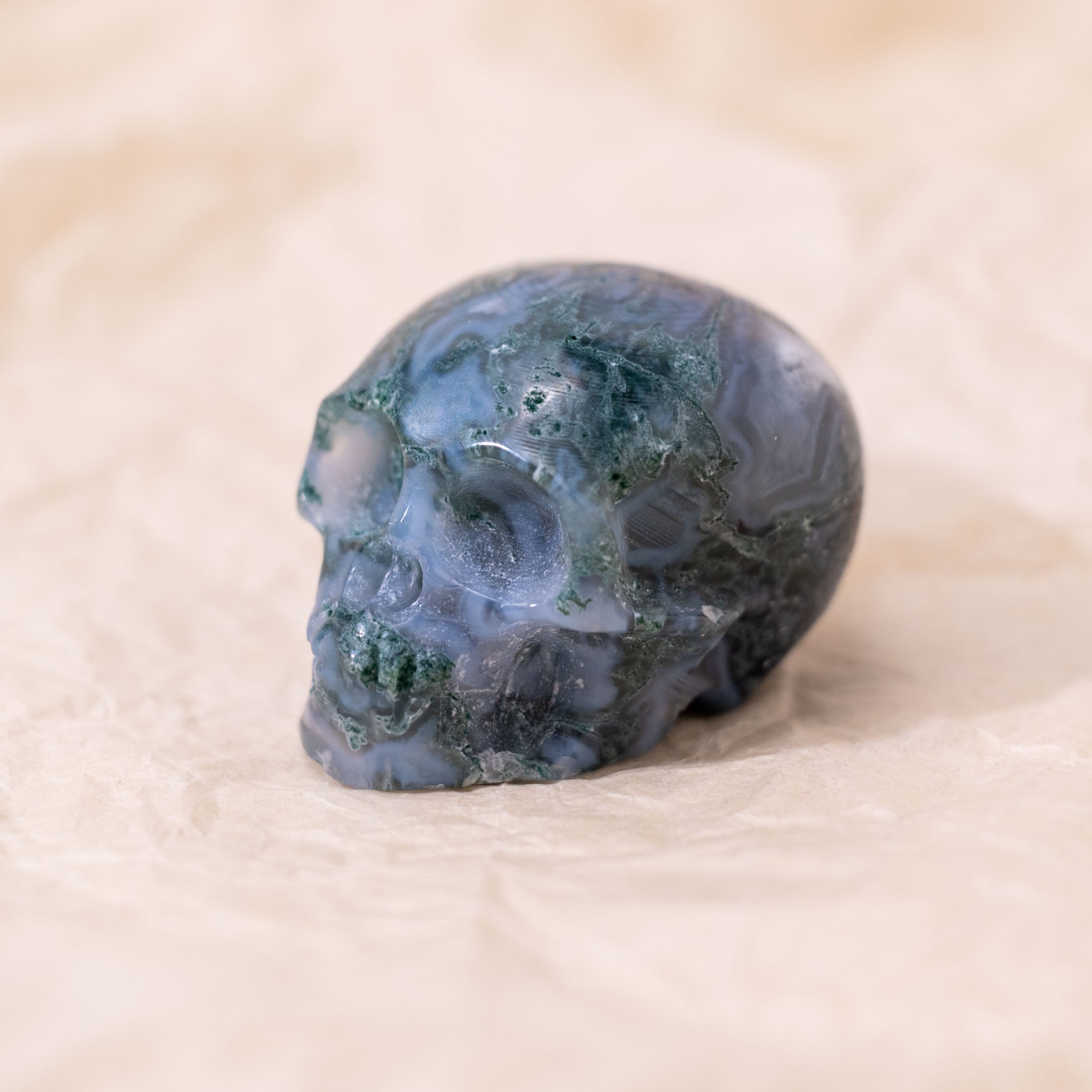 The Moss Agate Mini Skull symbolizes growth and renewal, connecting with nature for emotional balance