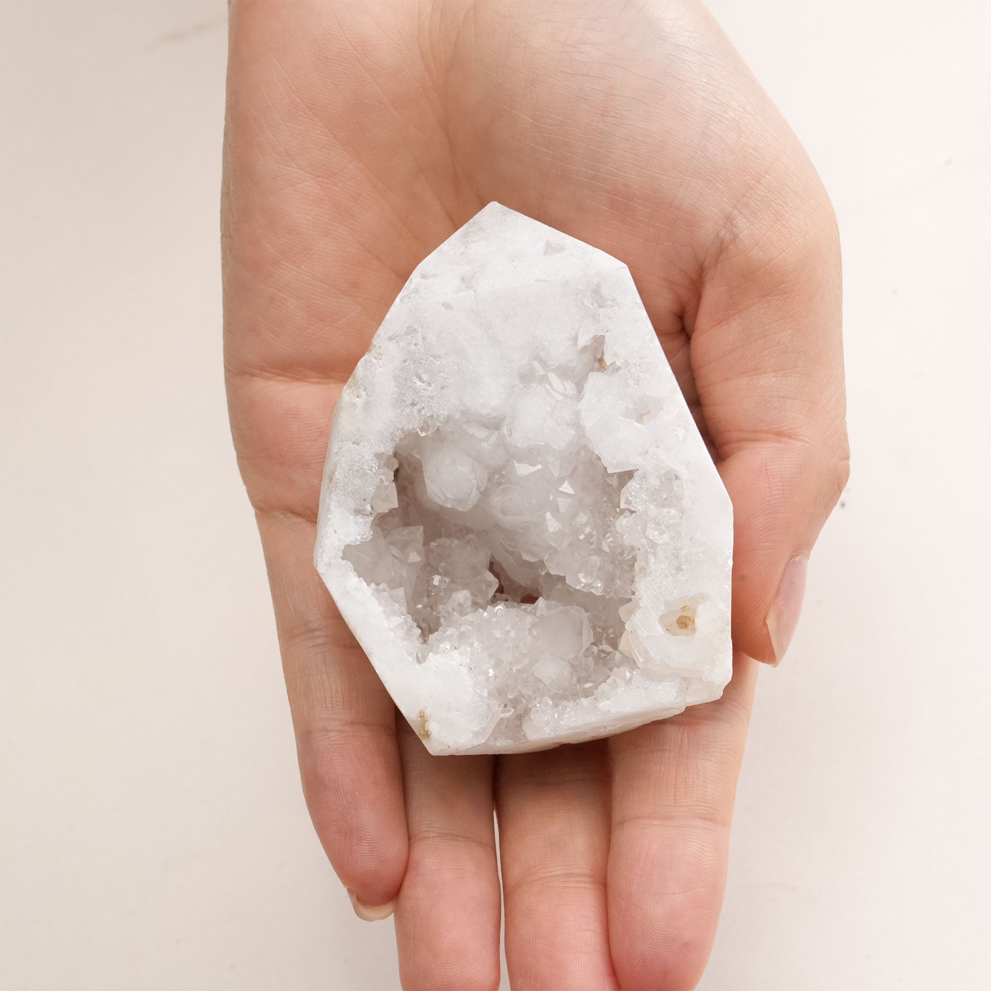 Handheld Clear Quartz Geode Freeform Crystal emphasizing its intricate crystal formations