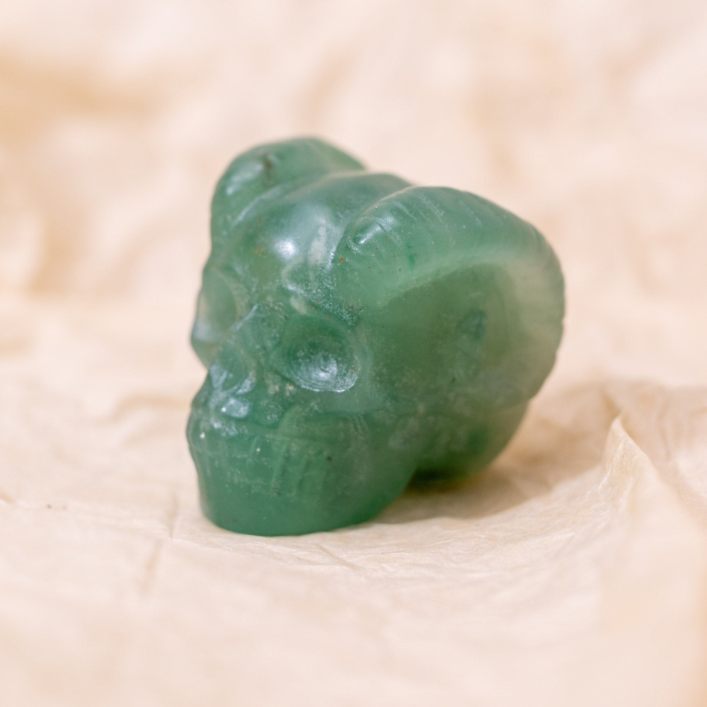 Handcrafted from Green Aventurine, this Mini Ram Horned Skull enhances emotional calm and attracts prosperity, making it a unique decorative piece.