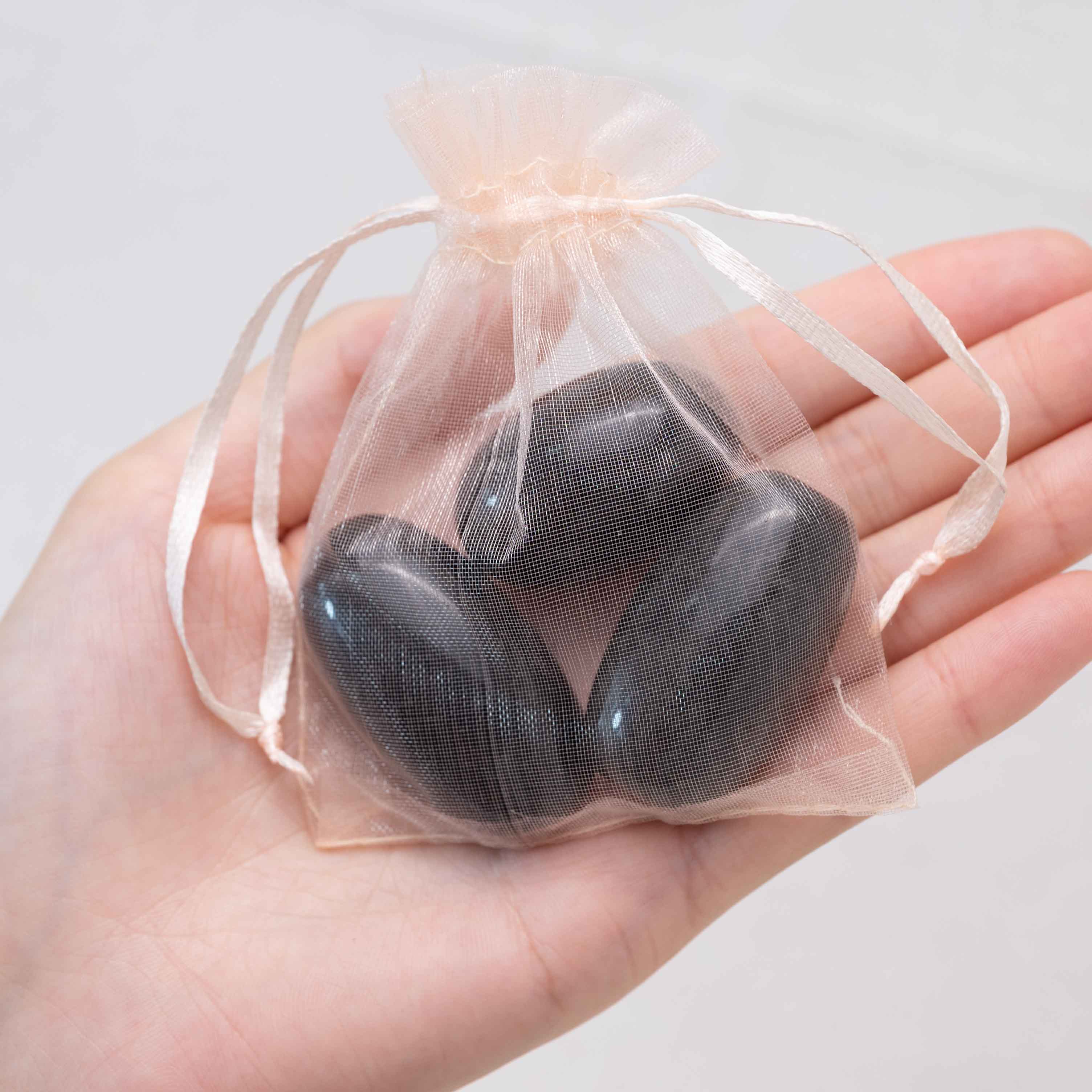 Detail shot of Silver Obsidian tumbled stone's metallic sheen