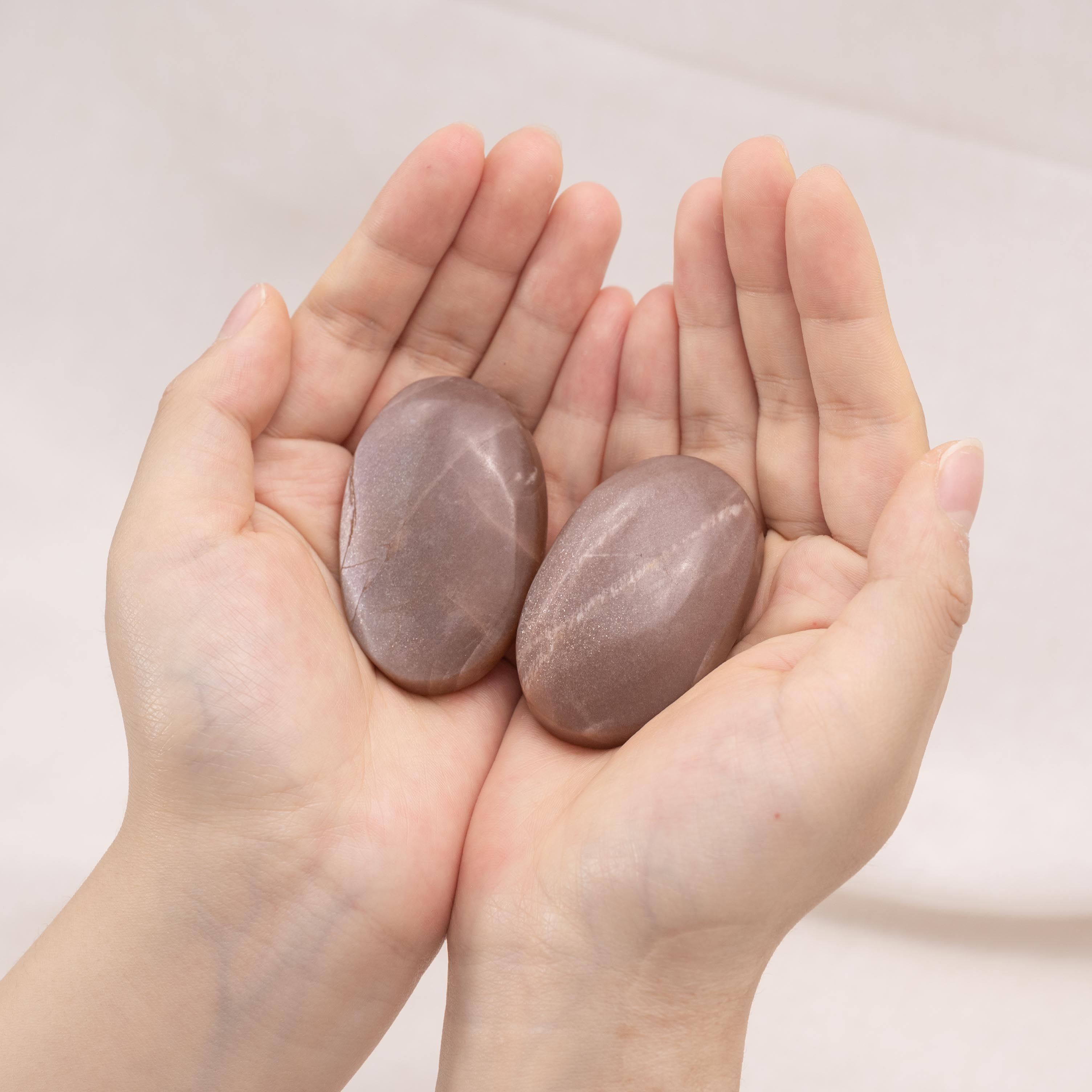 Golden Sun Stone Palm Stone showcasing stunning golden layers and textures