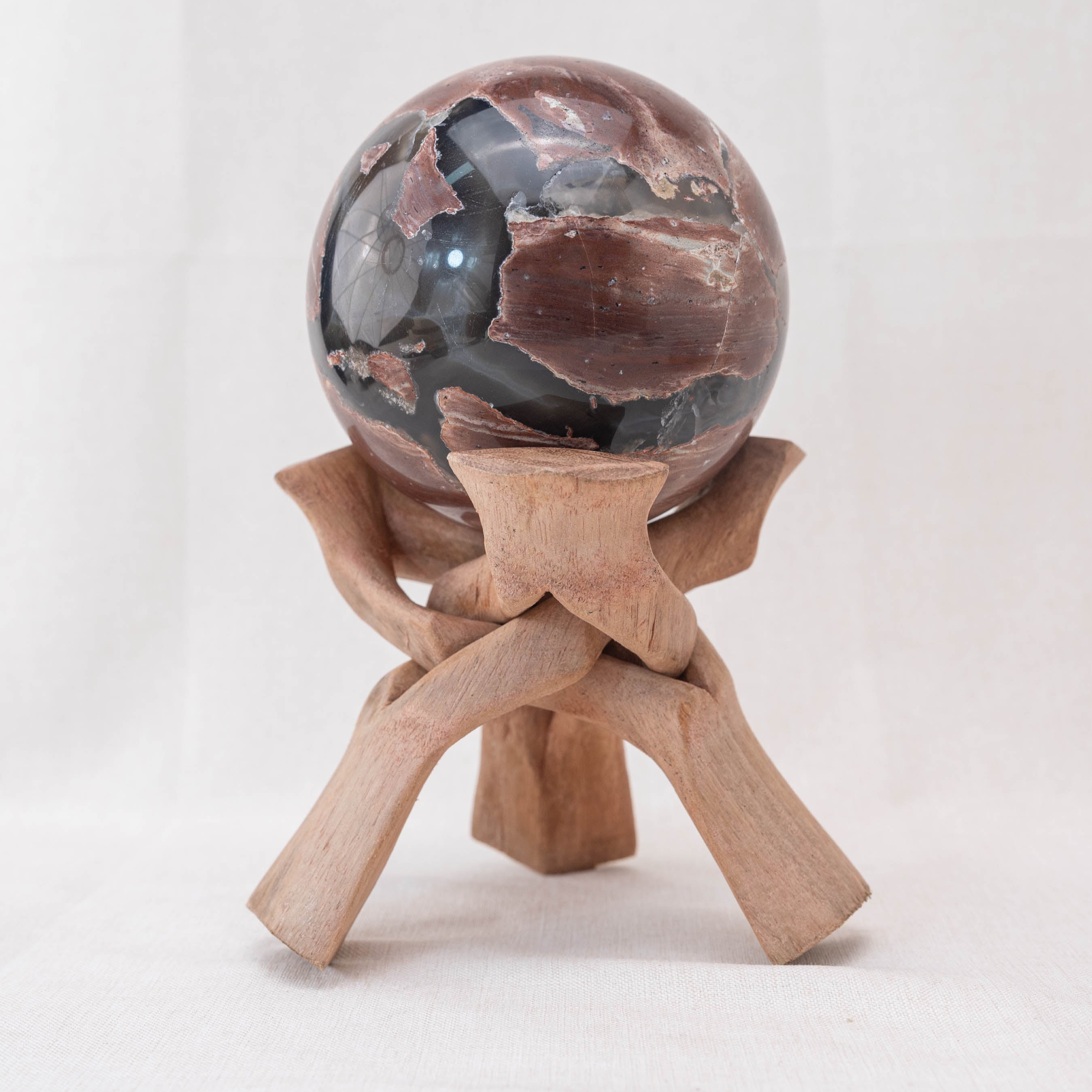 The wooden tripod stand is ideal for showcasing the beauty of your crystal collection.