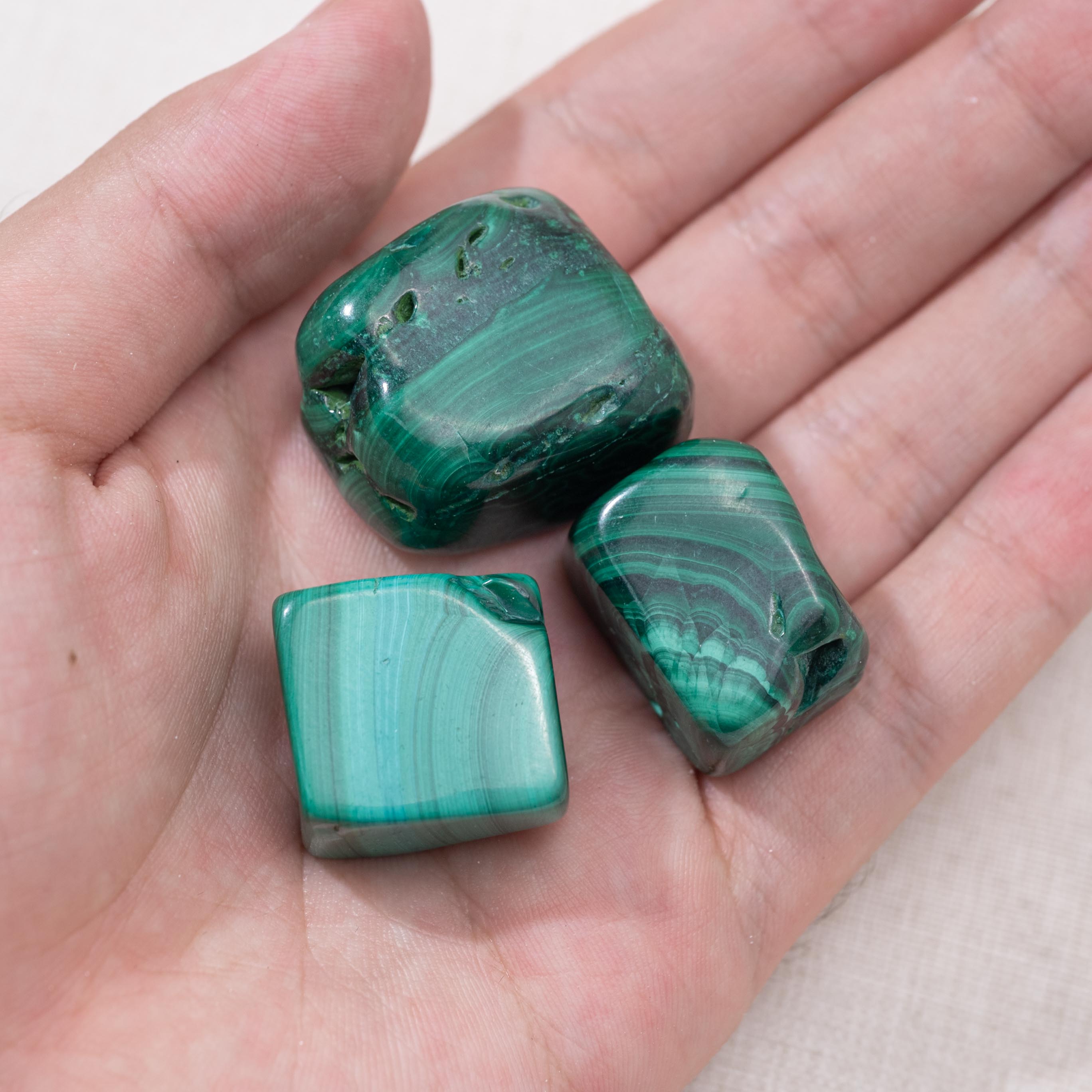 Enhance your meditation practice with this Malachite Tumbled Stone, known for its calming and protective energies.