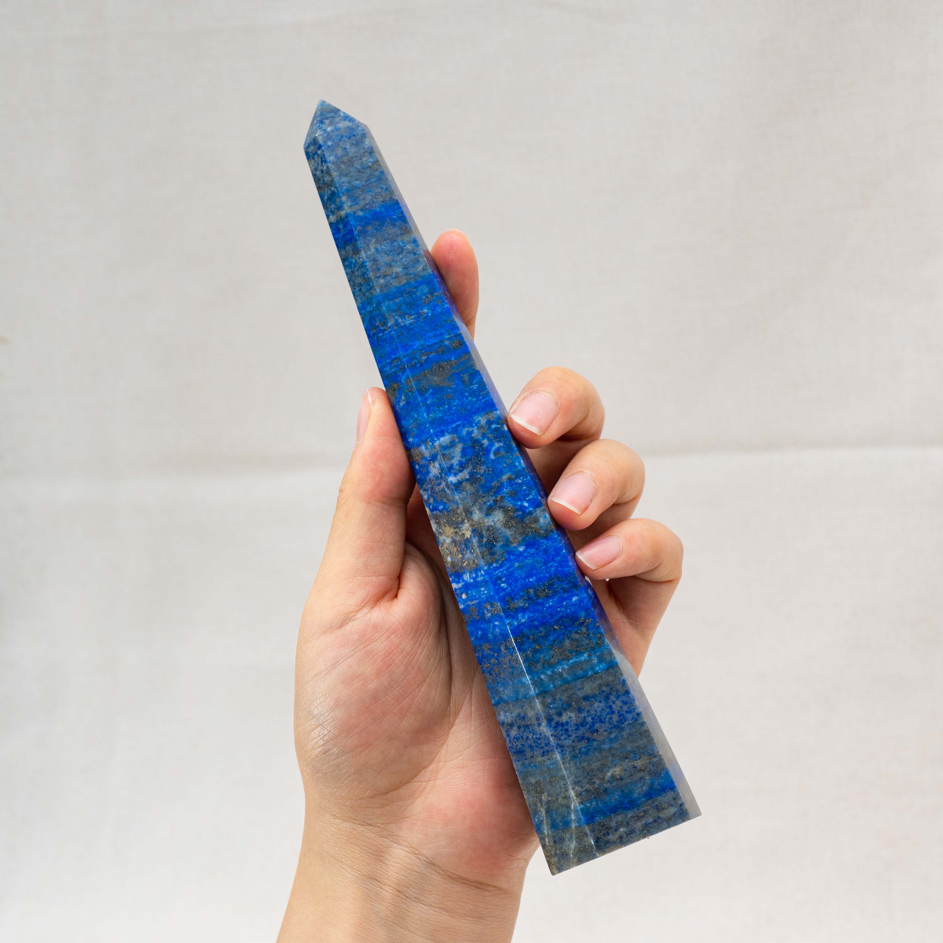Handcrafted from natural Lapis Lazuli, this tower enhances spiritual growth and emotional balance, making it a must-have for any crystal collection