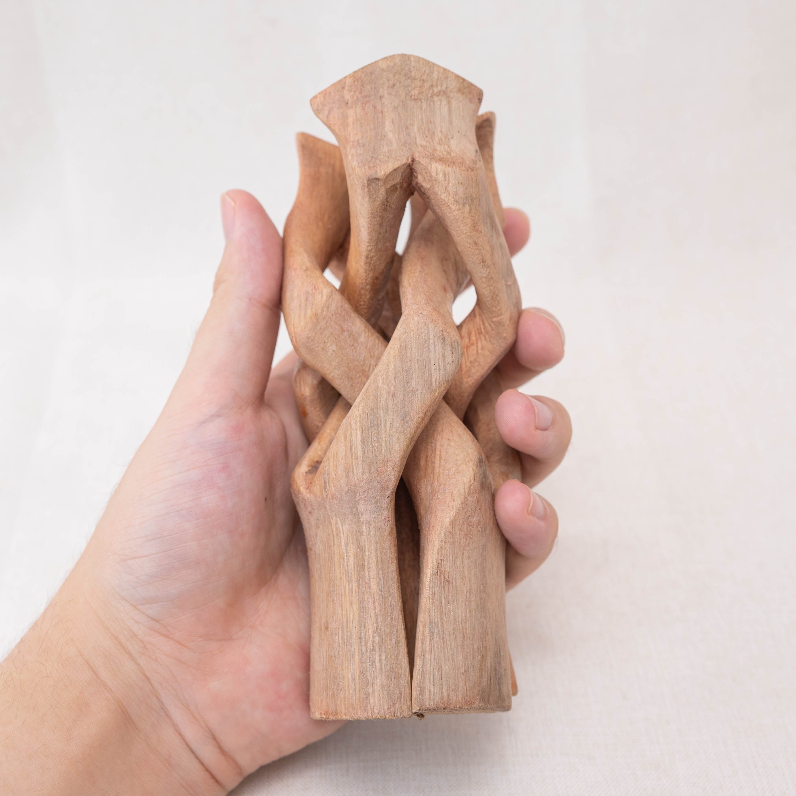 This wooden tripod stand features a natural wood finish that complements any decor style.