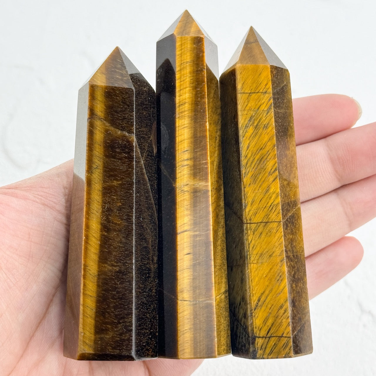 Polished yellow tiger eye stone point