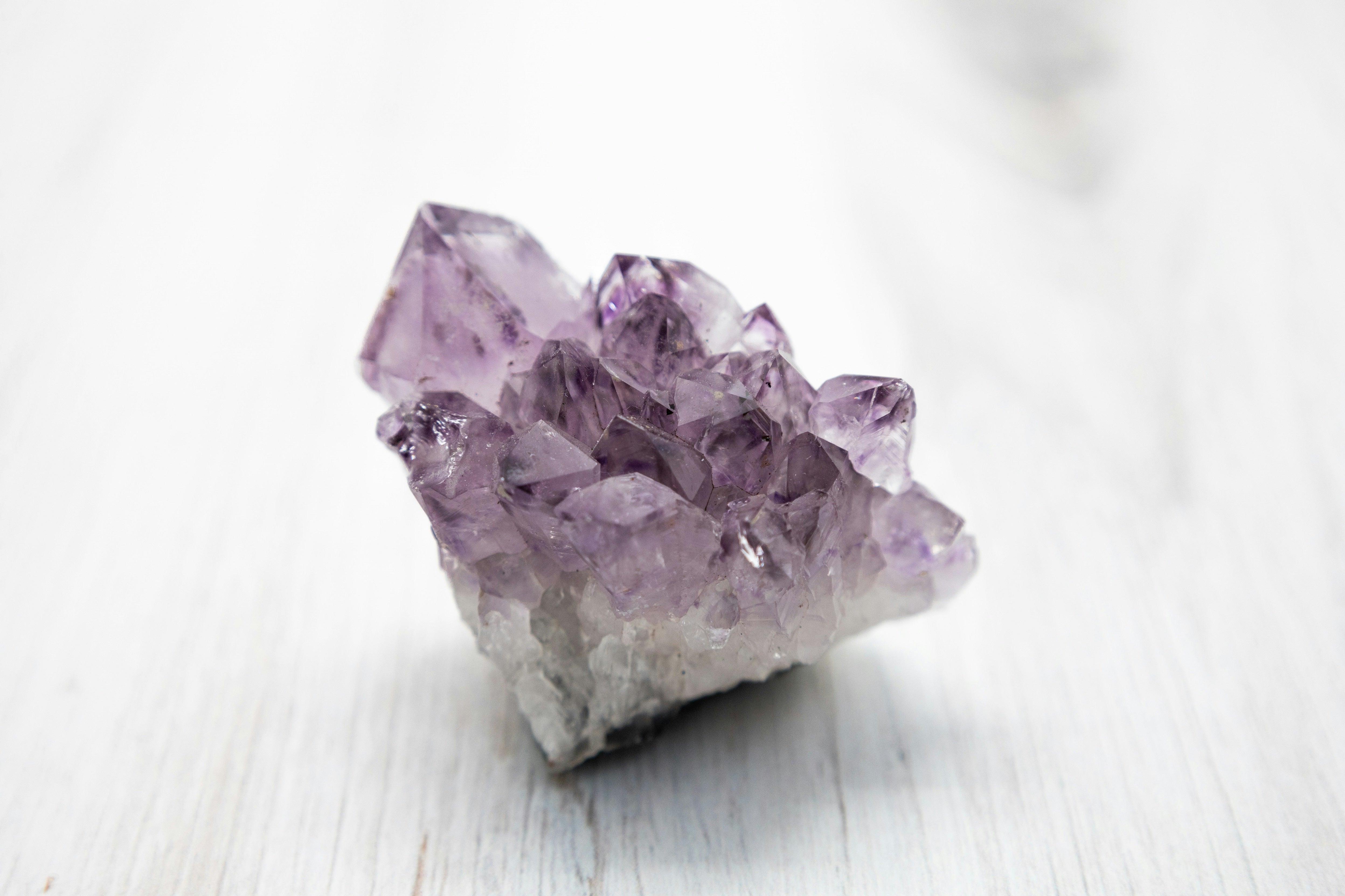 Purple Amethyst crystal has a transparent and unusual crystalline structure. Under natural light, the crystal is smooth and reflective. This image shows Amethyst's inherent beauty, perfect for décor, spirituality, and mineral collections.