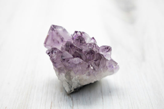 Purple Amethyst crystal has a transparent and unusual crystalline structure. Under natural light, the crystal is smooth and reflective. This image shows Amethyst's inherent beauty, perfect for décor, spirituality, and mineral collections.