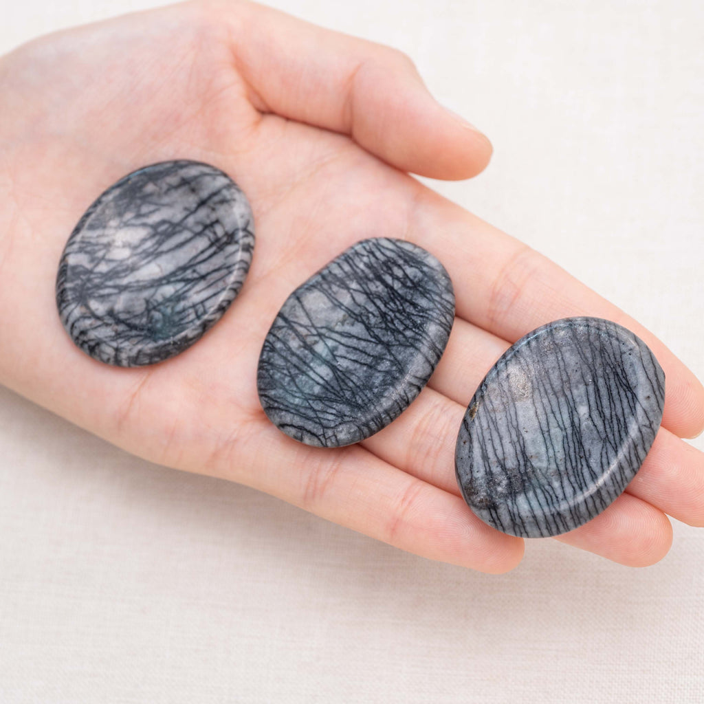 Known for its intricate black web patterns, the Black Net Worry Stone helps dispel negative energies