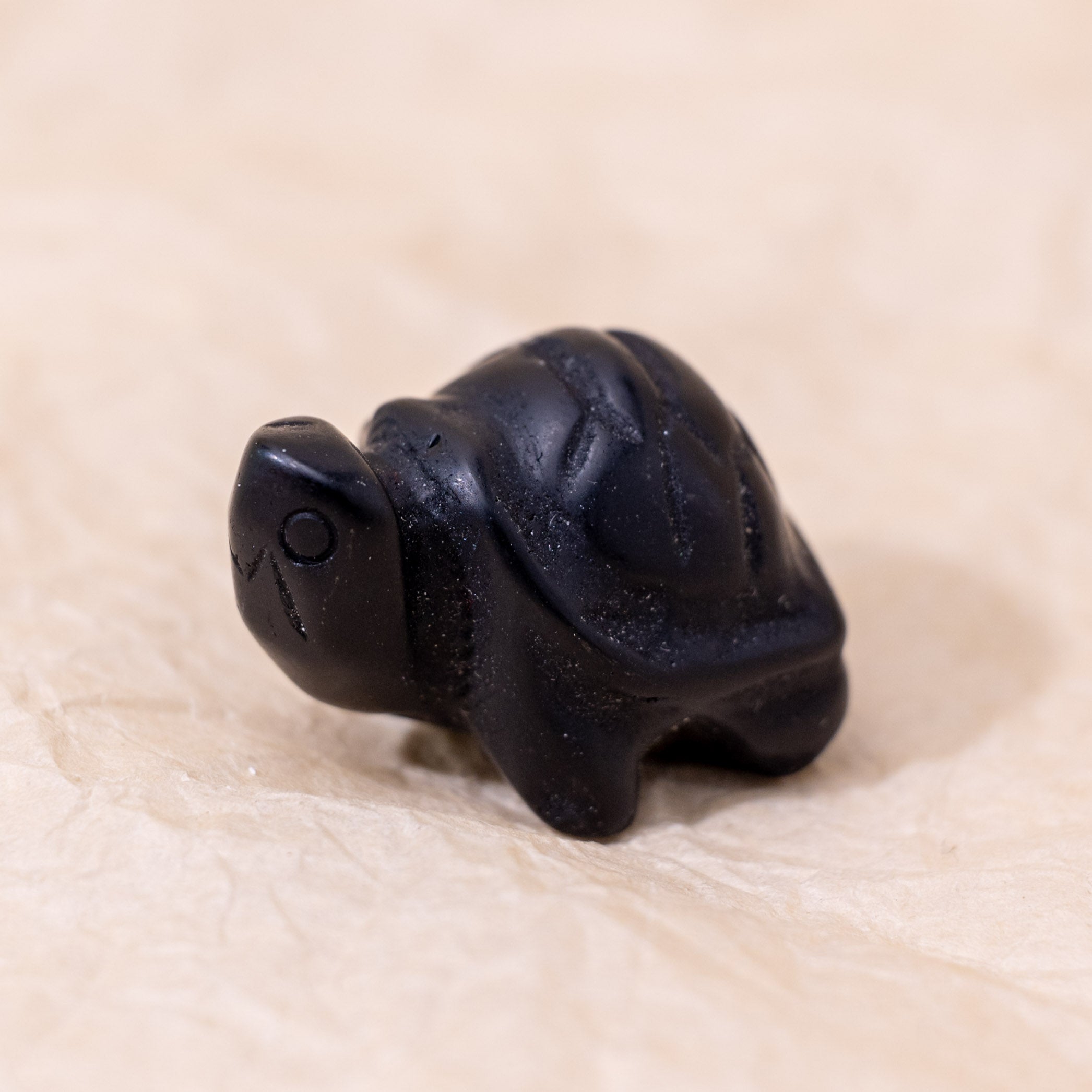 The Black Obsidian Mini Turtle absorbs negative energies, promoting emotional balance and mental clarity.