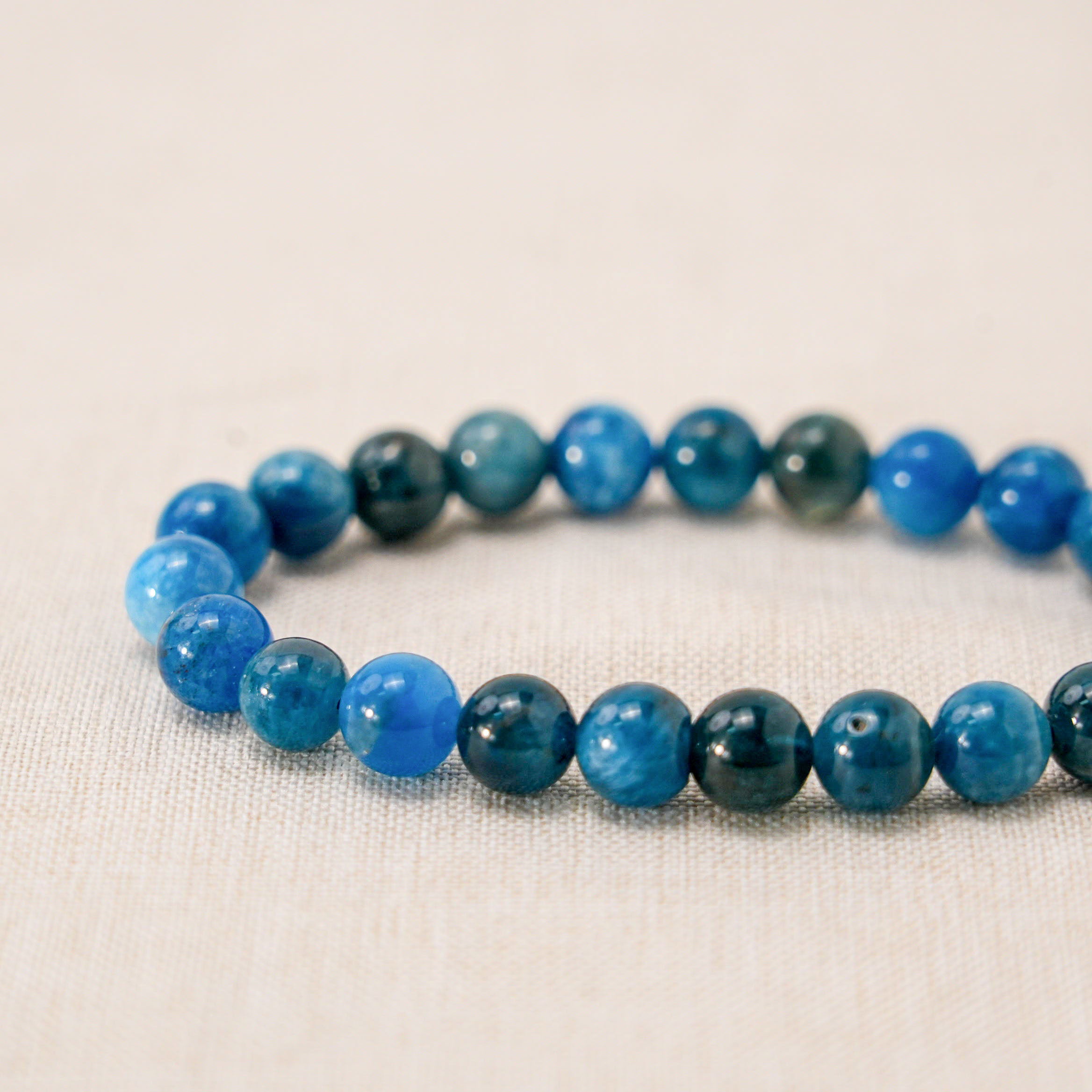 Elegant Blue Apatite bracelet with silver charms for stylish healing. 