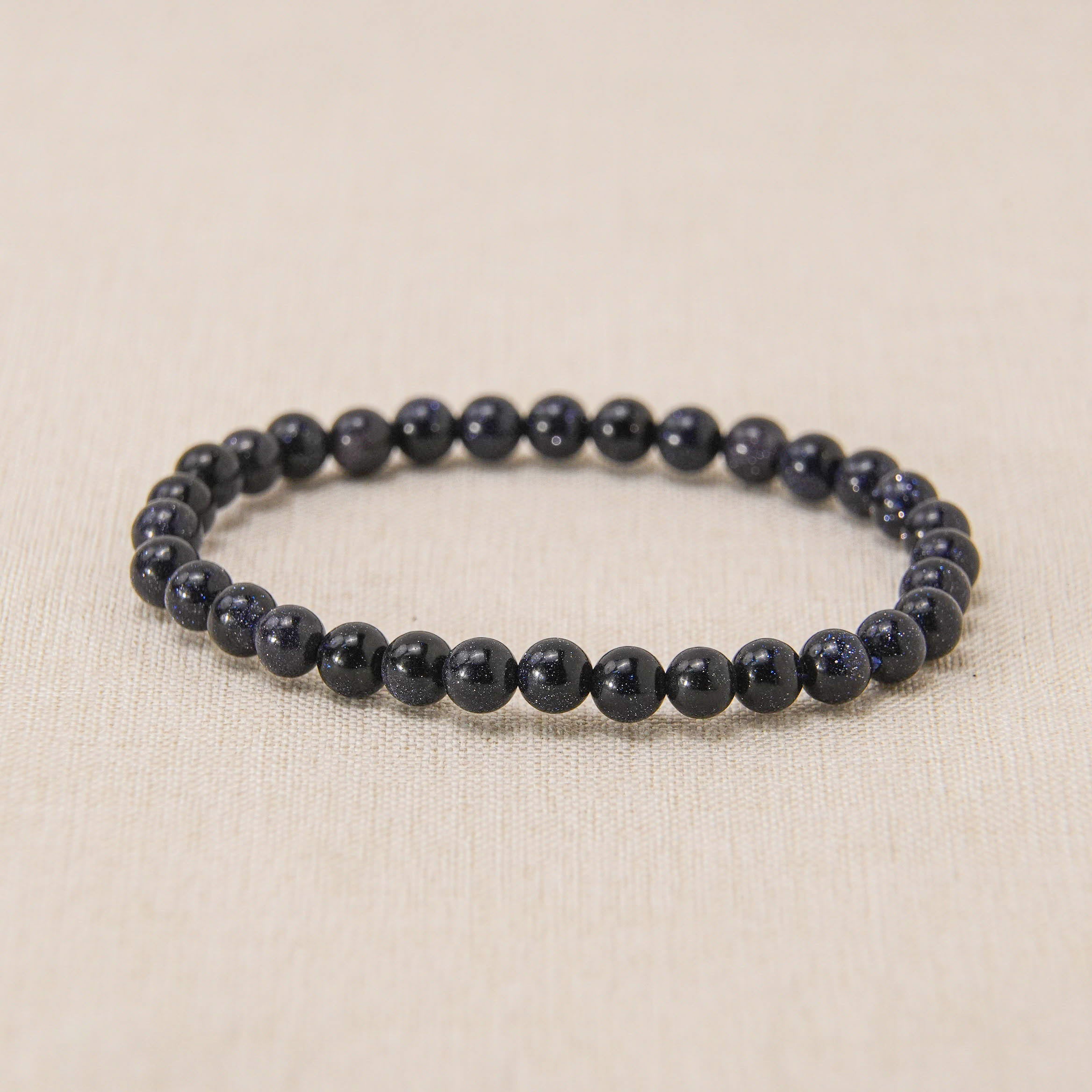 Blue Sand Stone Bracelet with dark blue crystals, enhancing inner peace and tranquility.