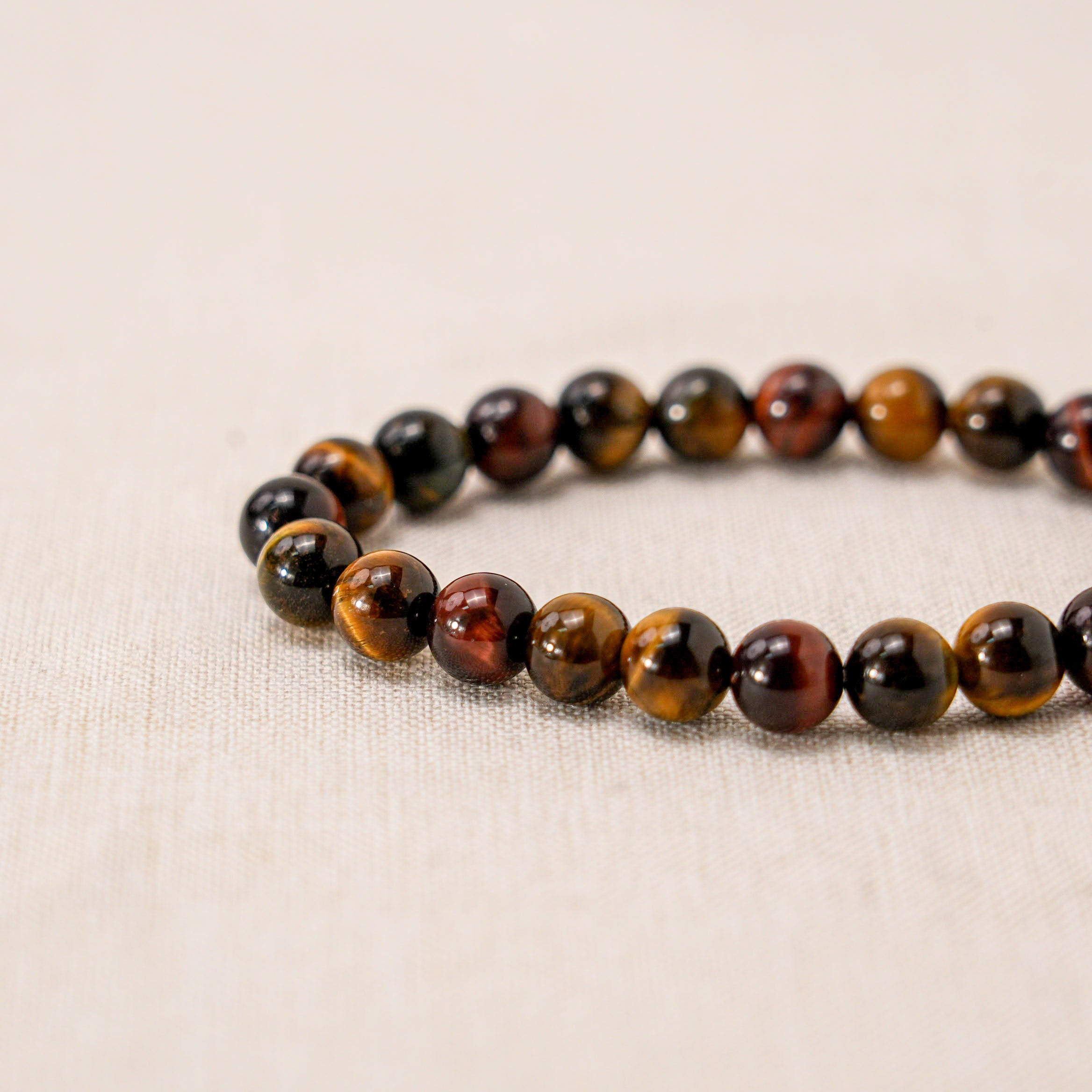 The tiger eye gemstones in this bracelet are associated with prosperity, abundance, and success