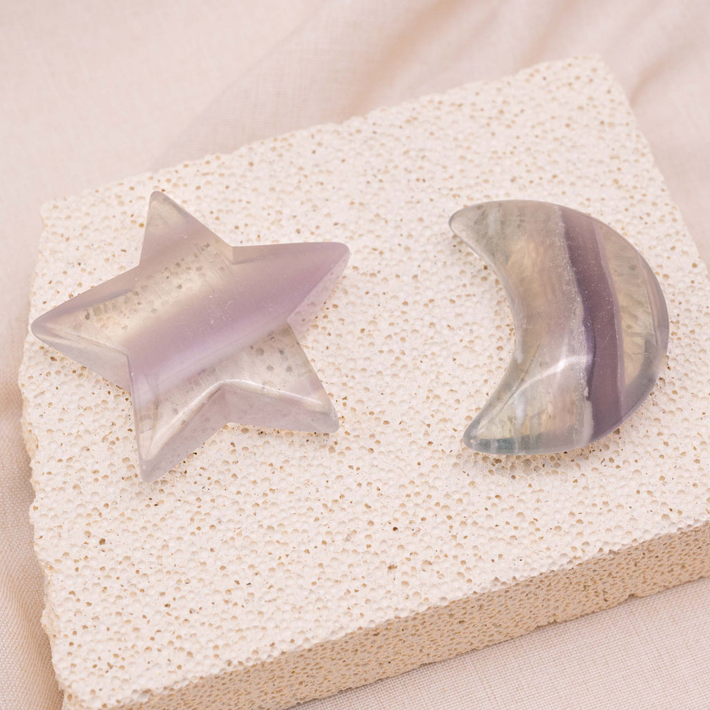Light Purple Fluorite Star/Moon Palm Stone held in hand