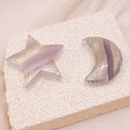 Light Purple Fluorite Star/Moon Palm Stone held in hand