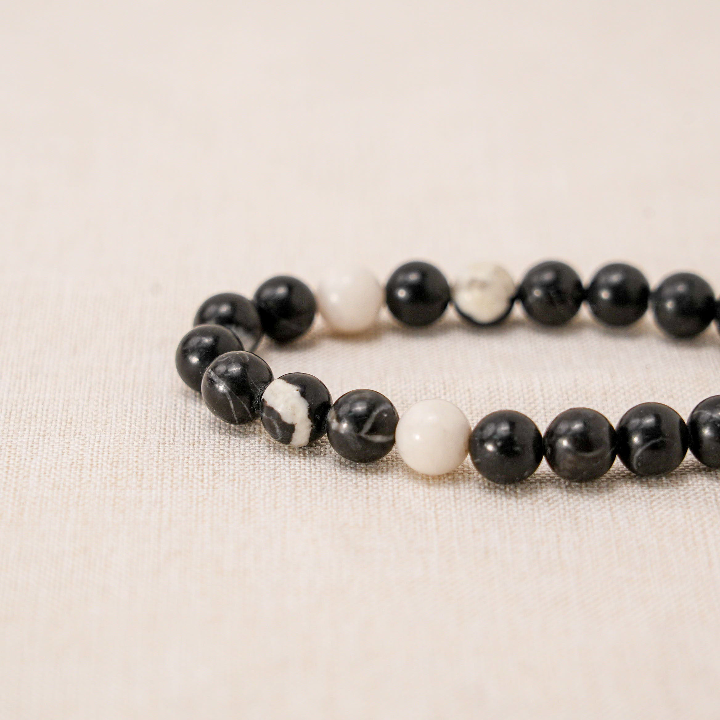 Unique black and white zebra jasper bracelet known for its grounding properties