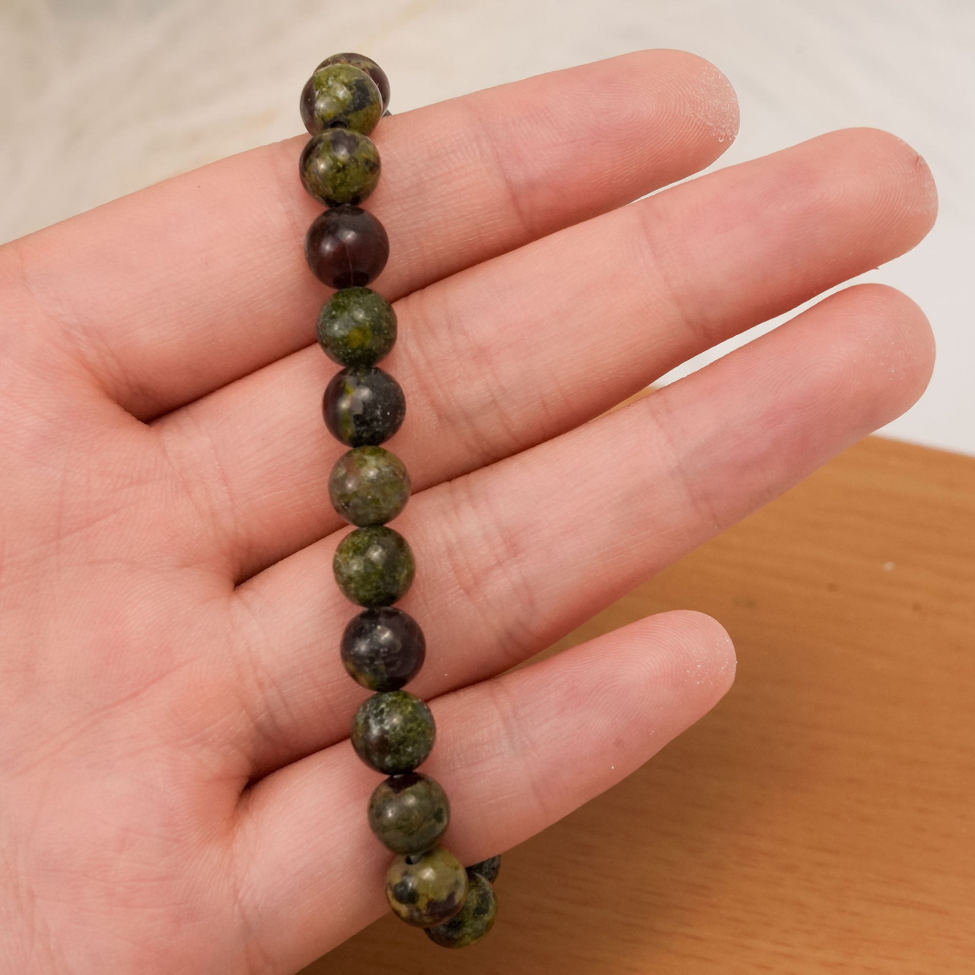 Dragon Blood Stone Bracelet showcasing unique red and green stones, perfect for promoting physical endurance and emotional balance