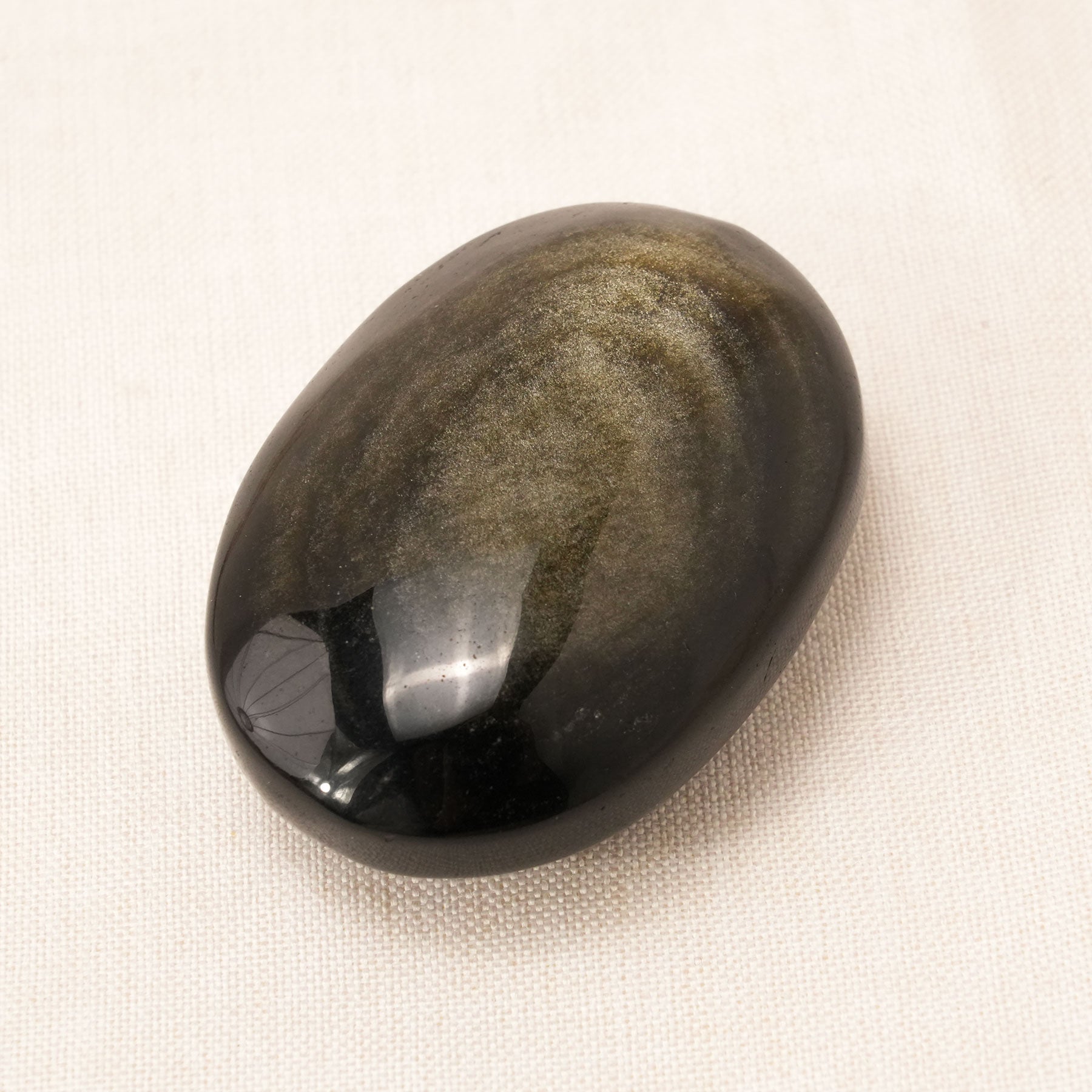 Golden Obsidian Palm Stone used for meditation and grounding energy