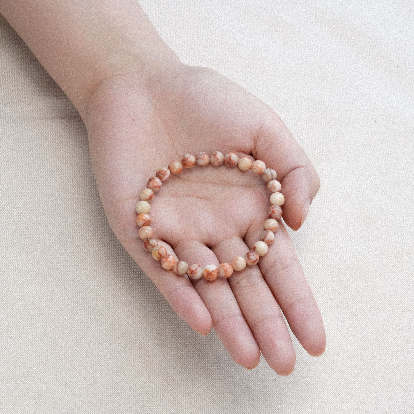 Vibrant Red Net Stone Bracelet with intricate designs, promoting emotional stability and grounding energy