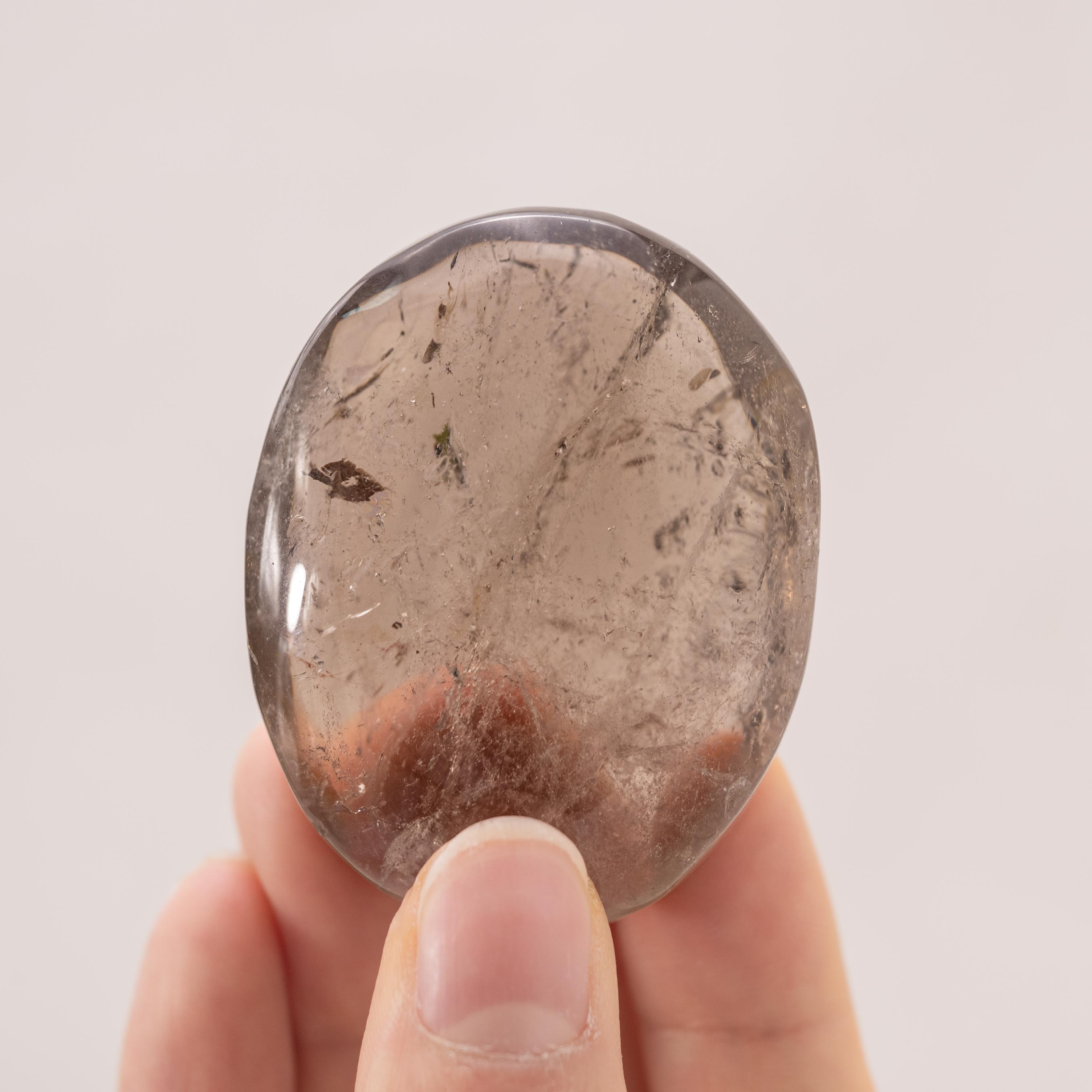 Smoky Quartz Palm Stone with rich brown hues and natural clarity